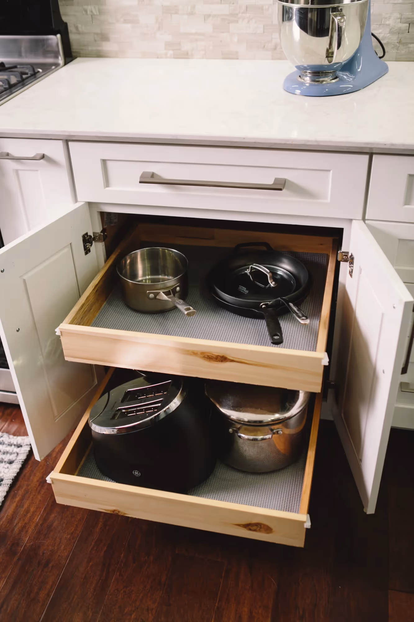 Open dishwasher with racks and utensils