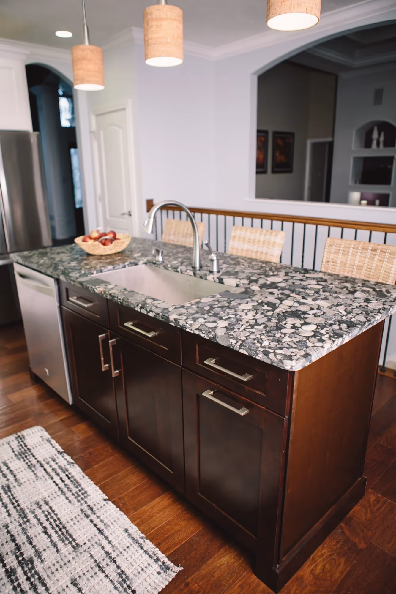 Modern kitchen with dark island and bar stools