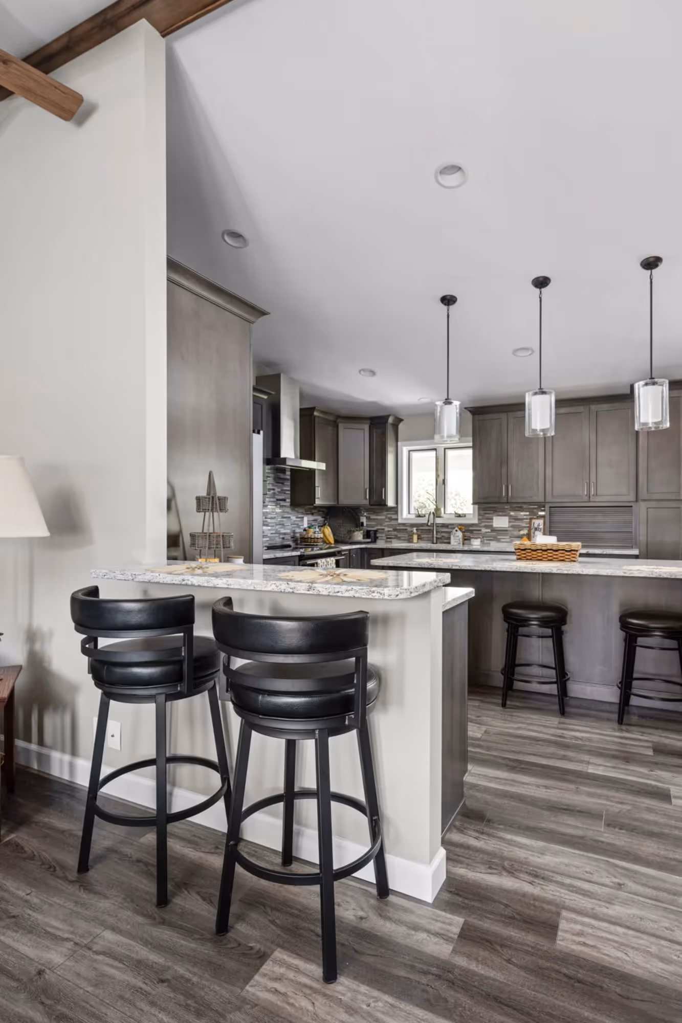 Kitchen island with bar stools and pendant lighting