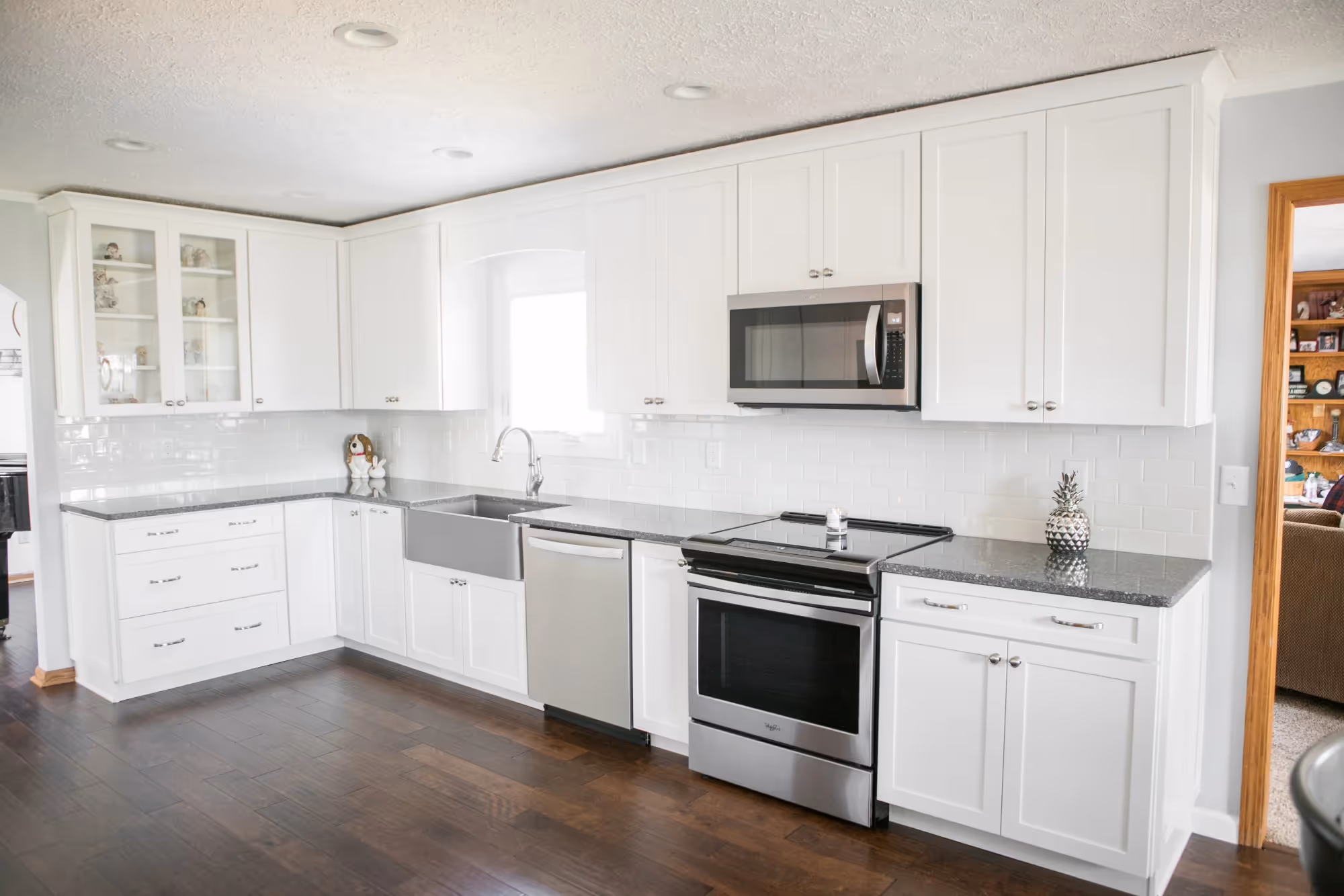 White kitchen with stainless steel stove and microwave