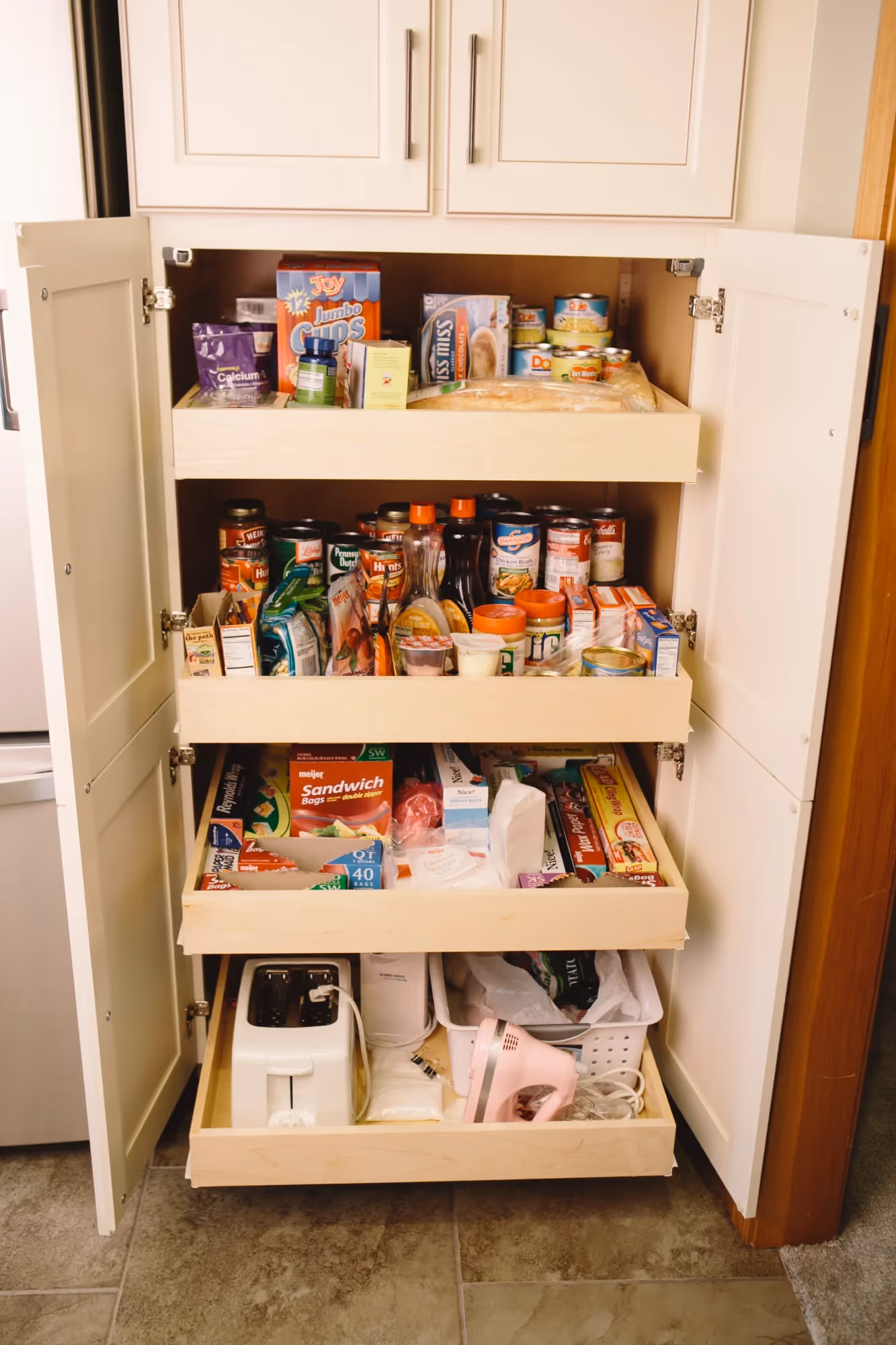 Wood cabinet with open shelves and storage bins