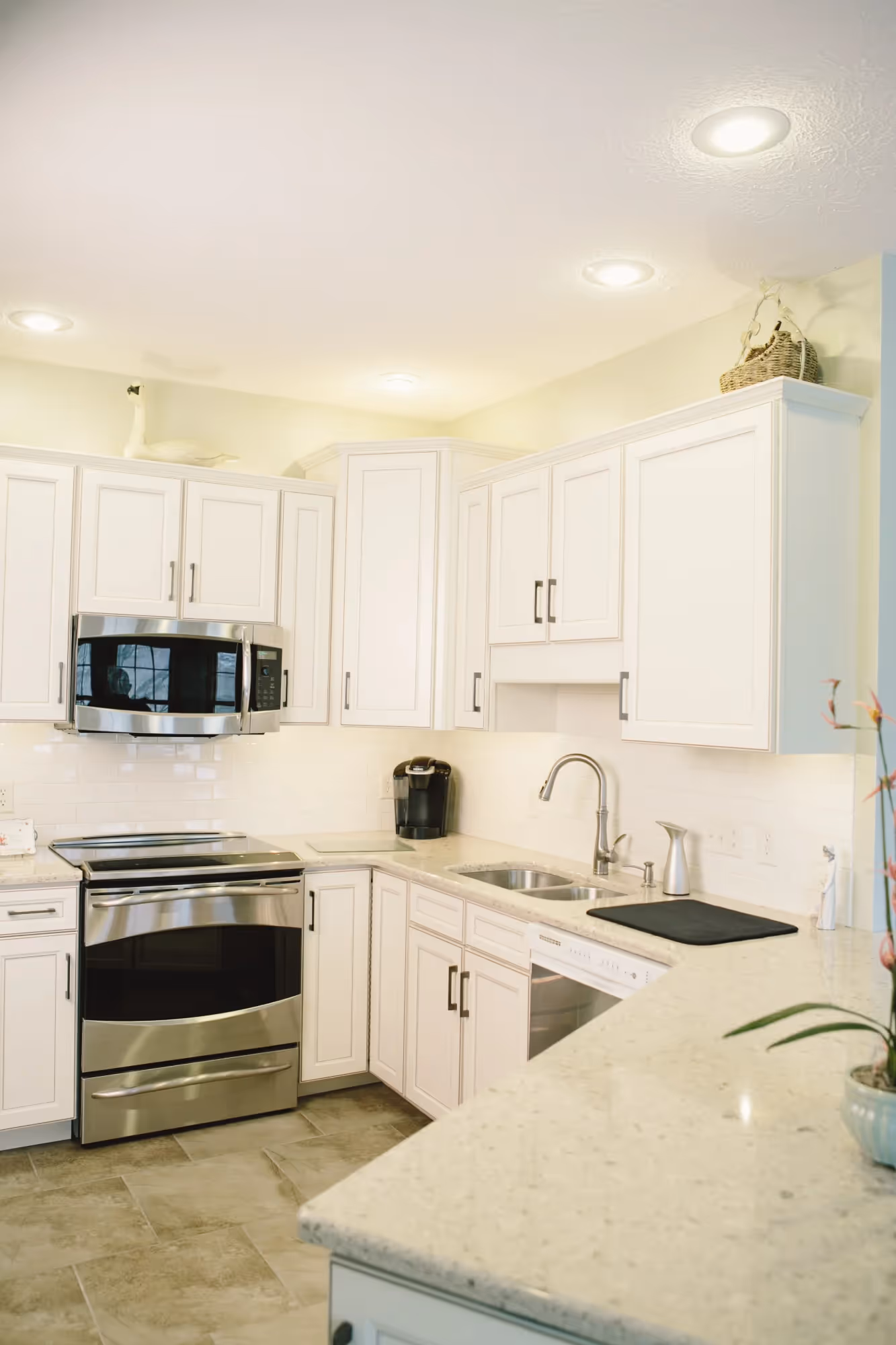 White kitchen with island and pendant lighting
