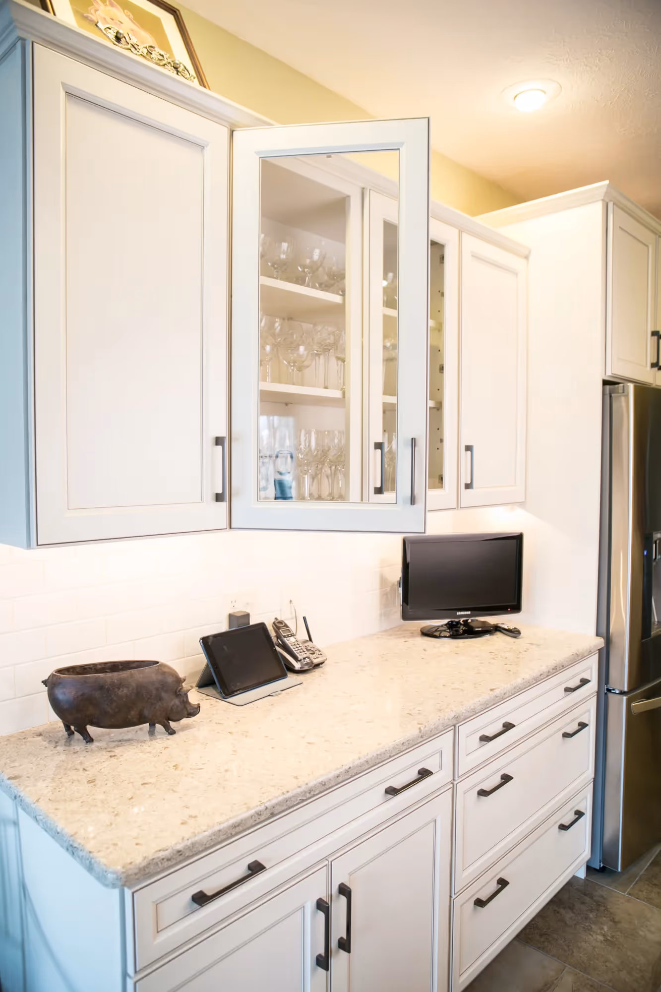Bathroom with twin sinks and light cabinetry.