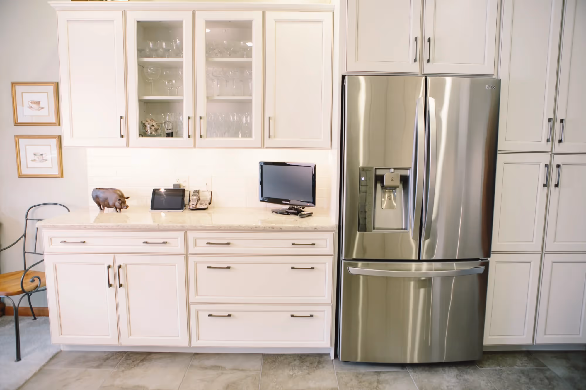 White kitchen cabinets with stainless steel refrigerator and microwave