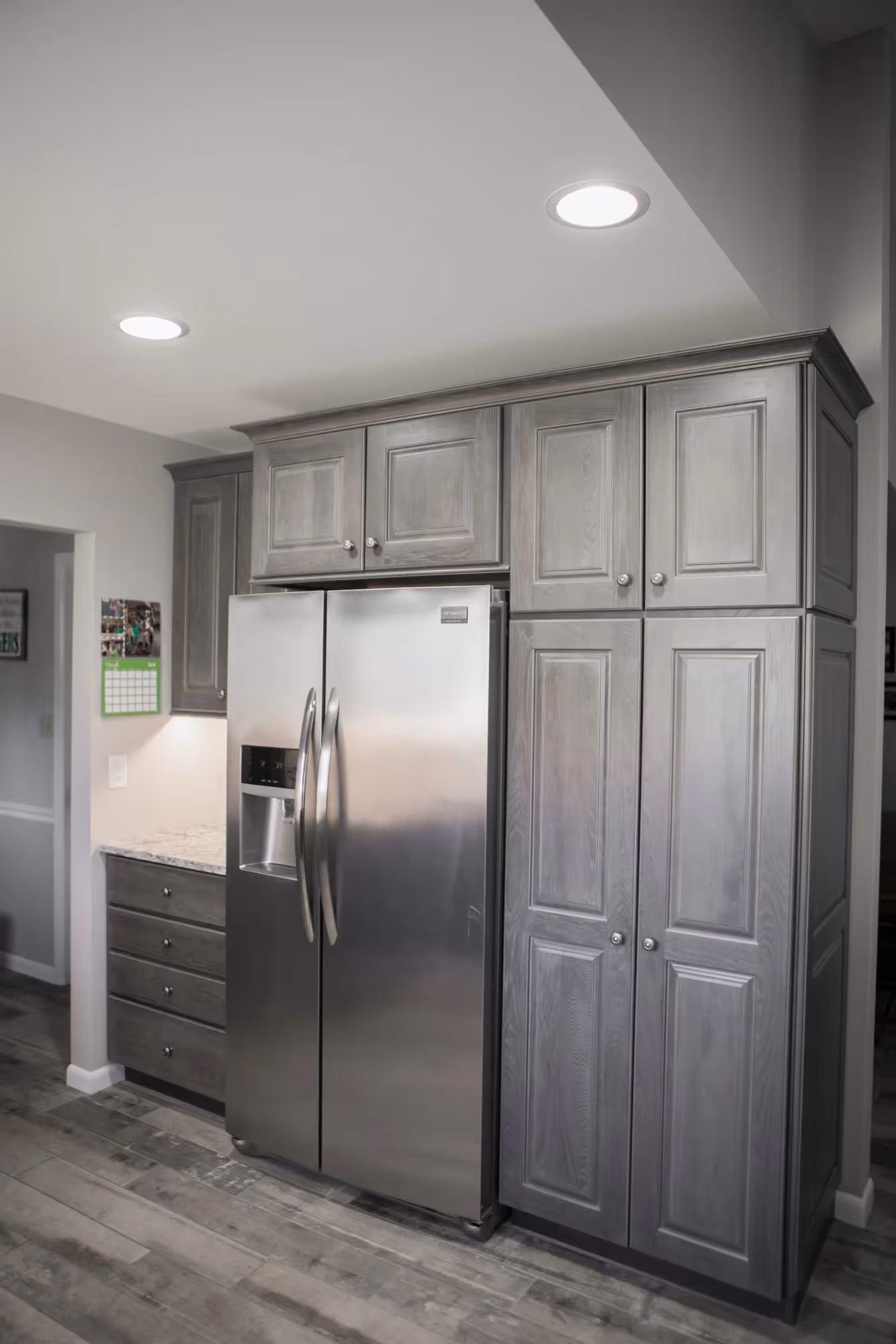Gray kitchen cabinetry with built-in appliances.