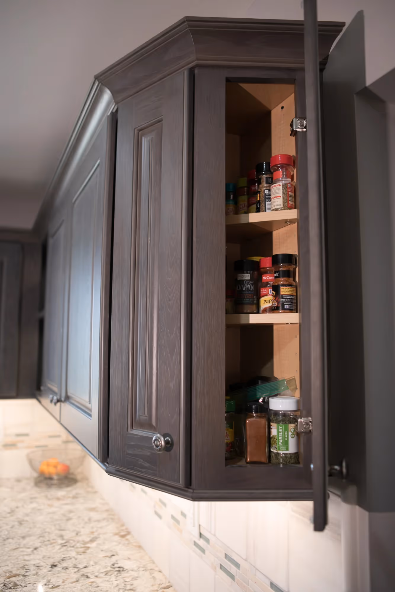 Kitchen with dark cabinetry and stainless steel appliances.