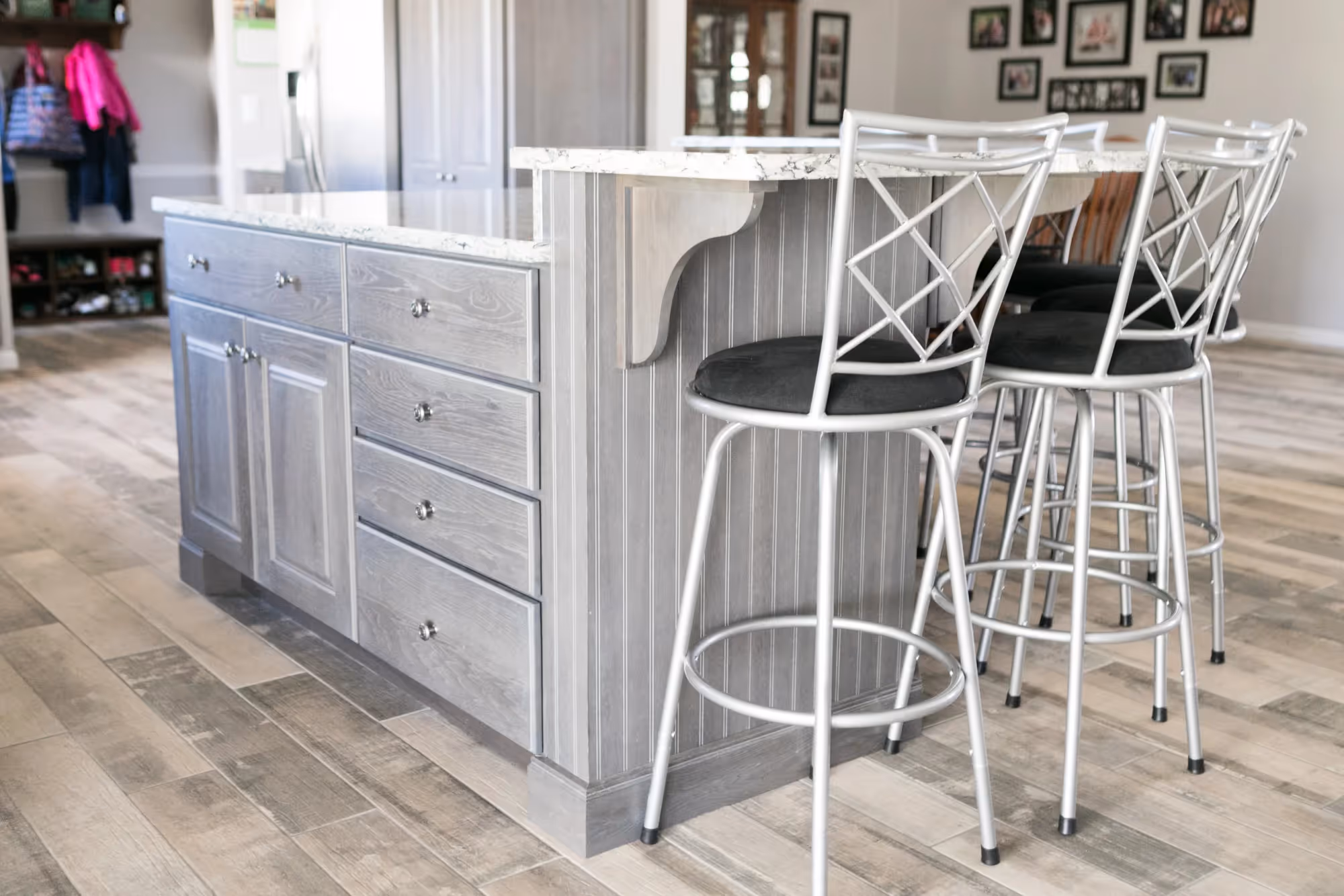 Bright kitchen island with bar stools and pendant lighting.
