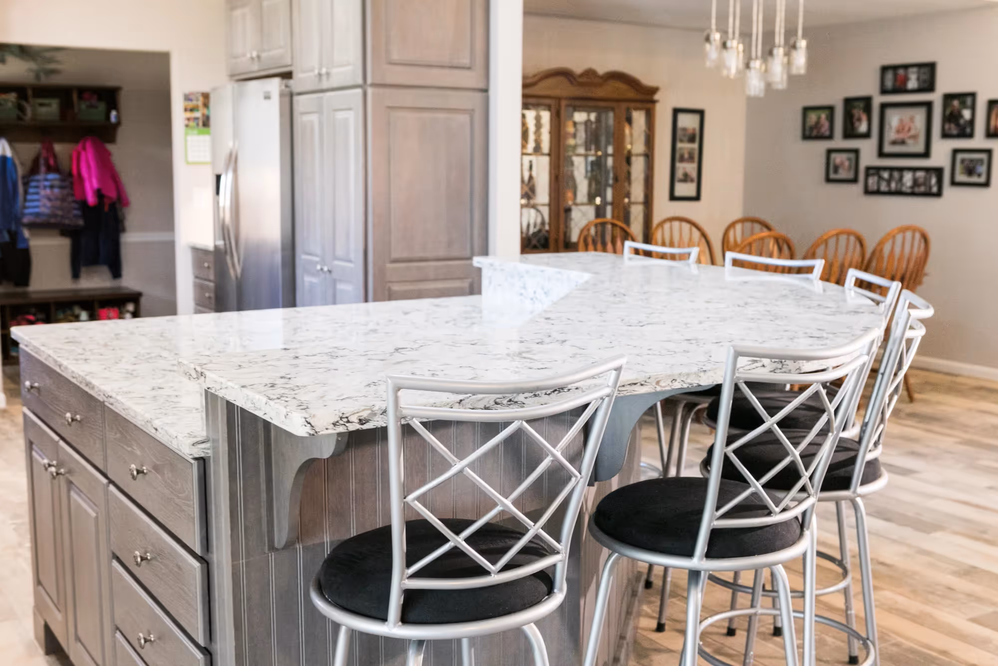 Kitchen with wooden cabinets, island, and pendant lighting.