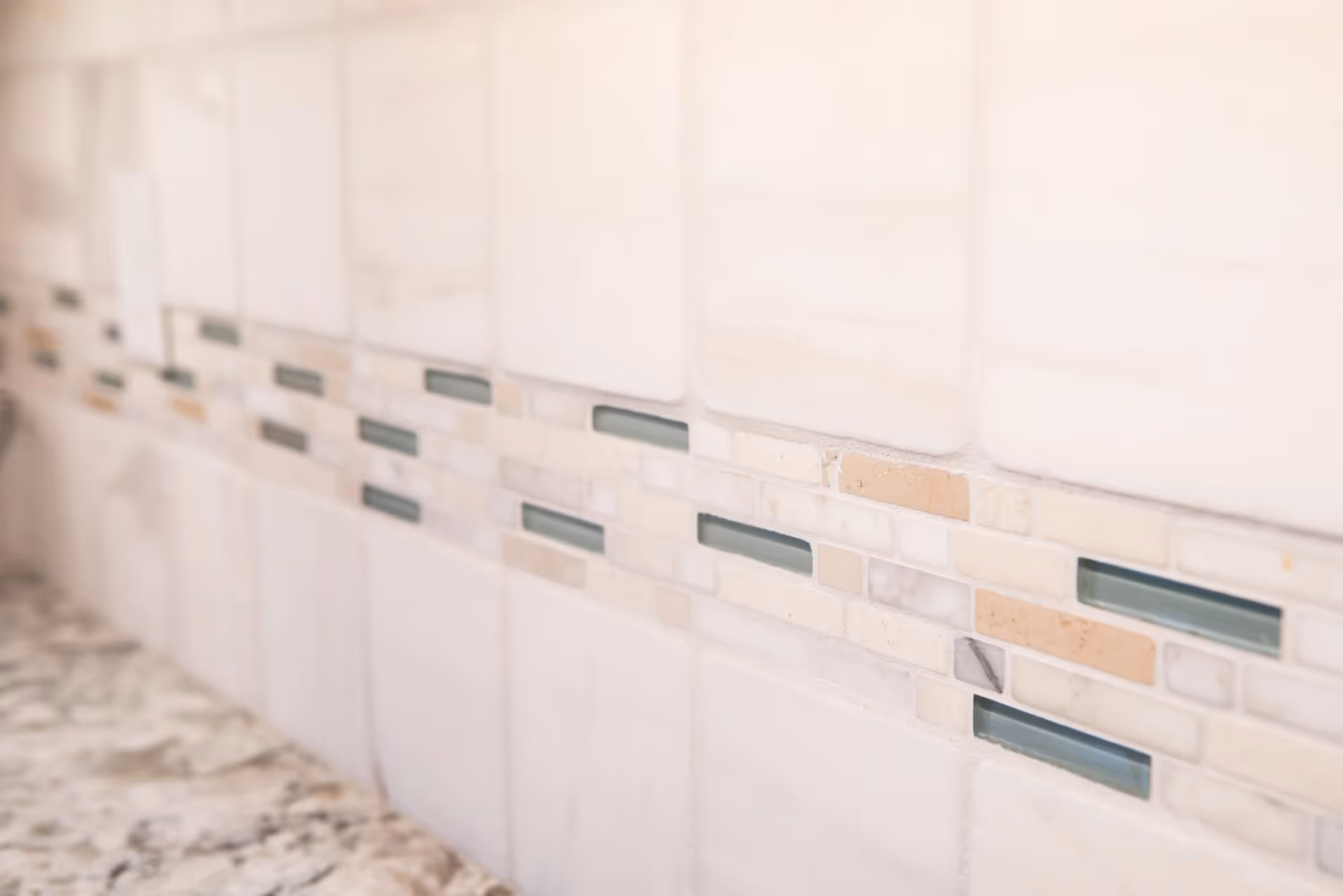 White tile wall with subtle gray accents in a modern interior.