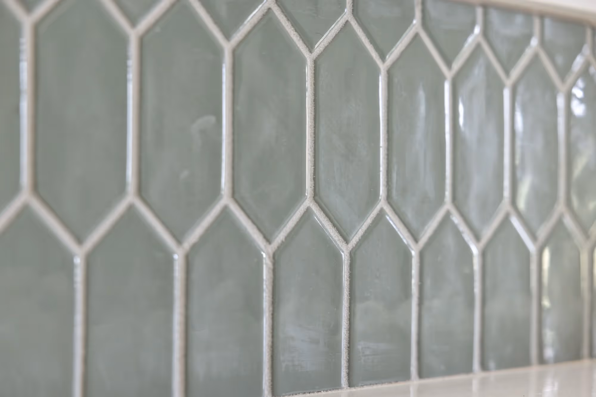 Green arched tile backsplash close-up