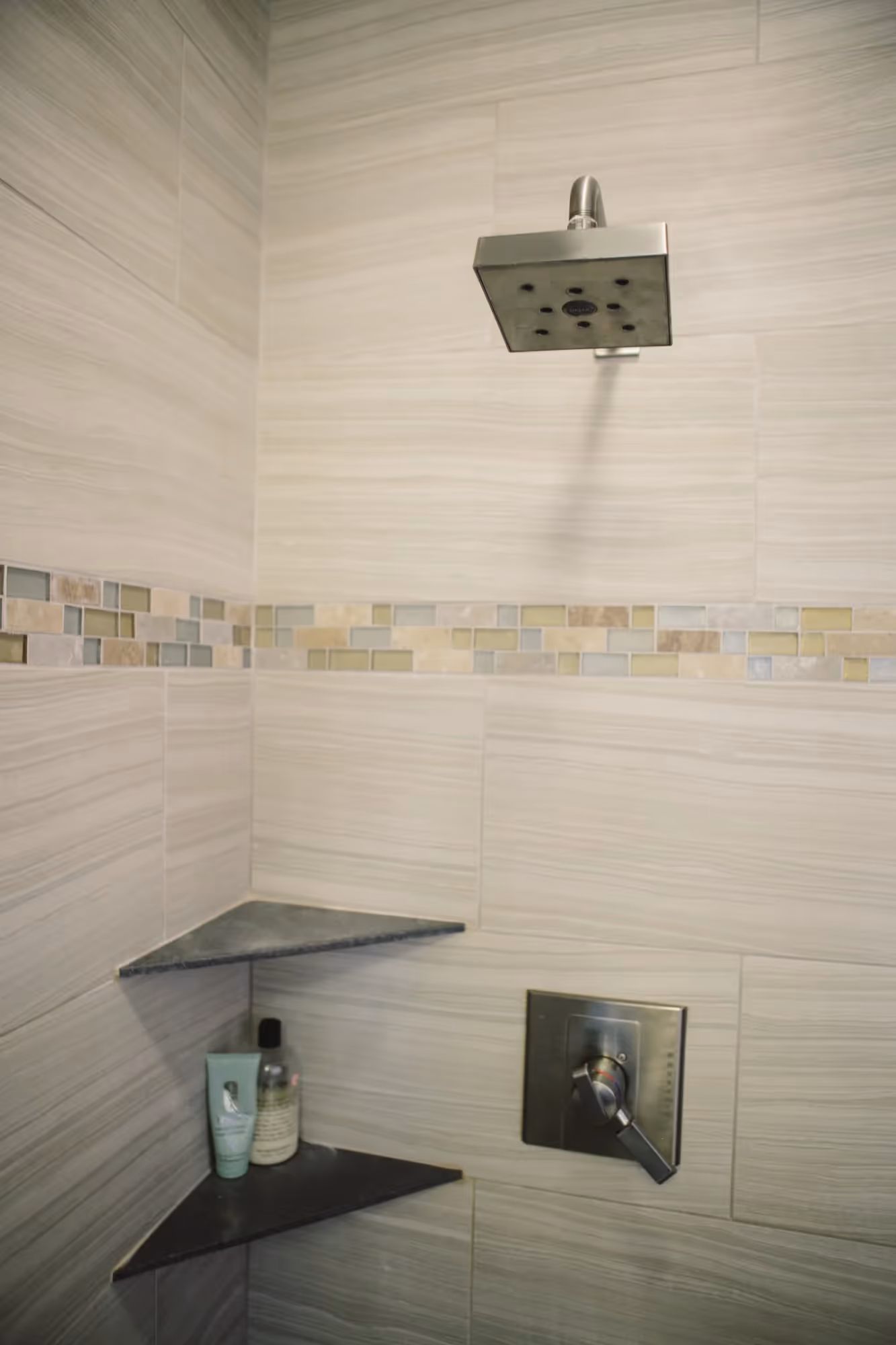Shower area with glass door and tiled walls