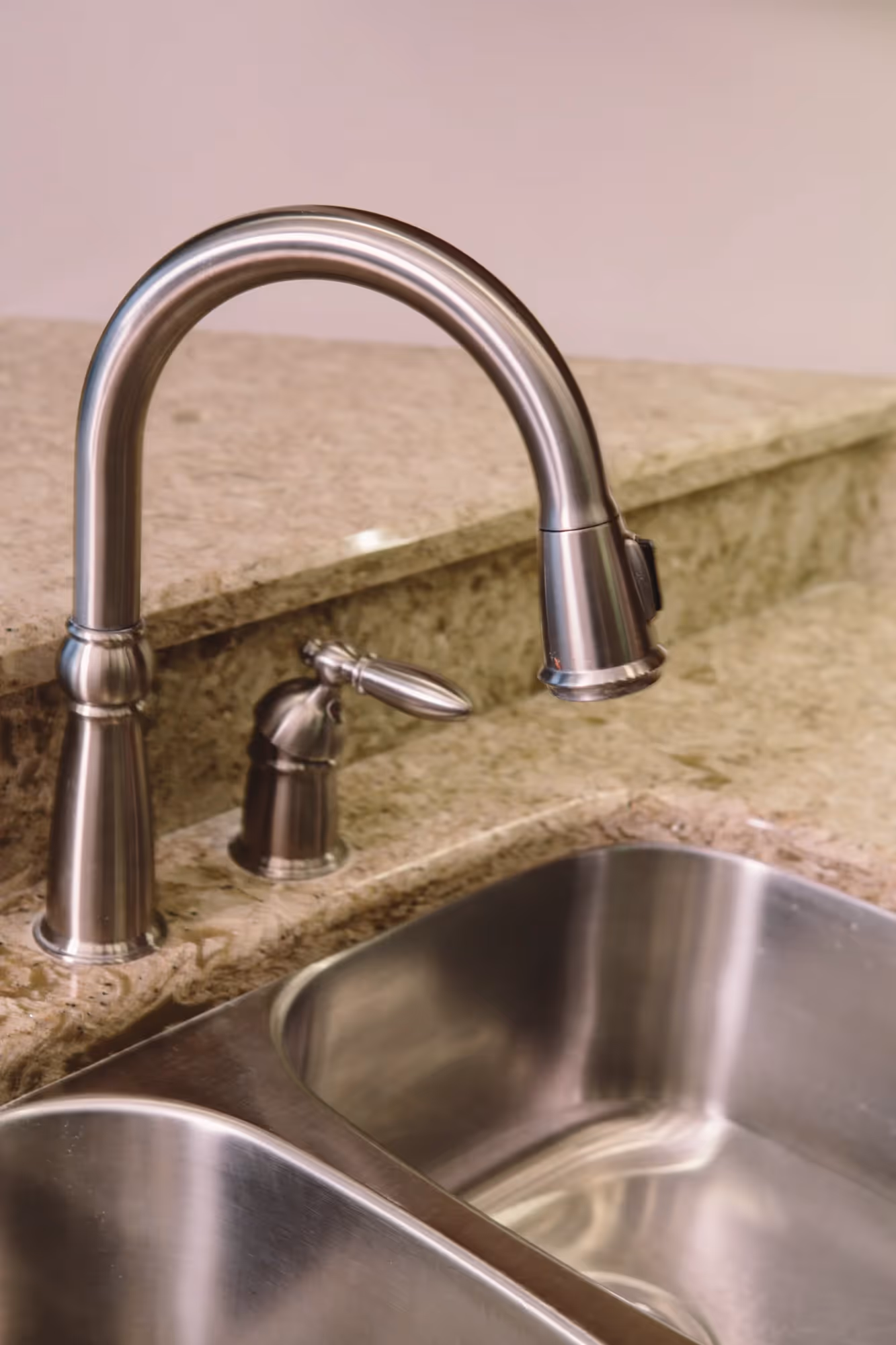 Brass kitchen faucet and sink detail