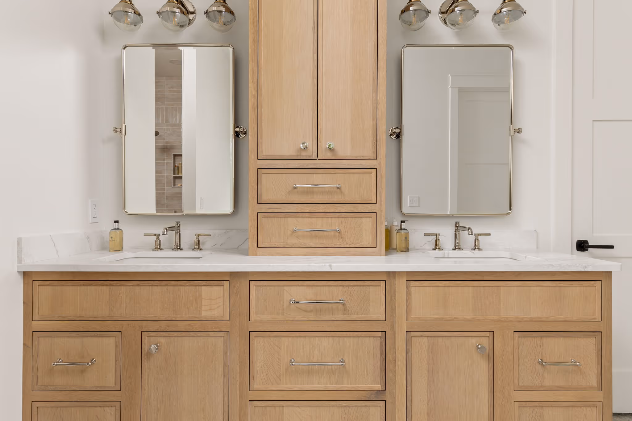 Double vanity with wood cabinets and mirrors