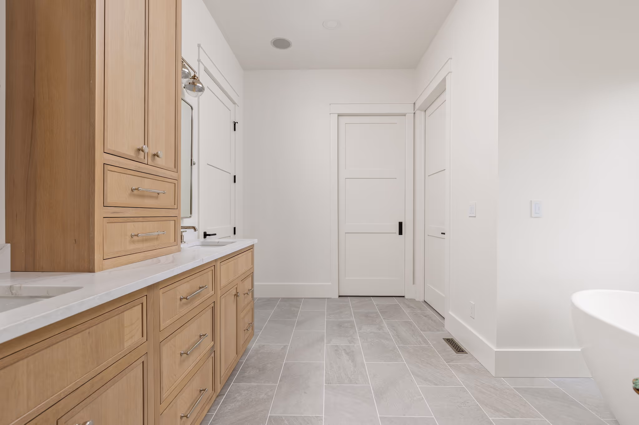 Bathroom with long vanity and gray tile floor