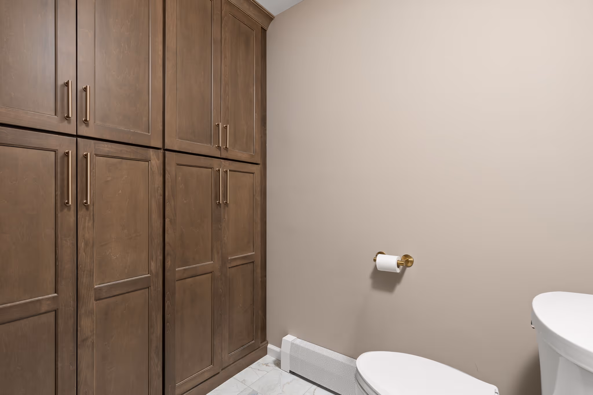 Bathroom with wood cabinets and toilet