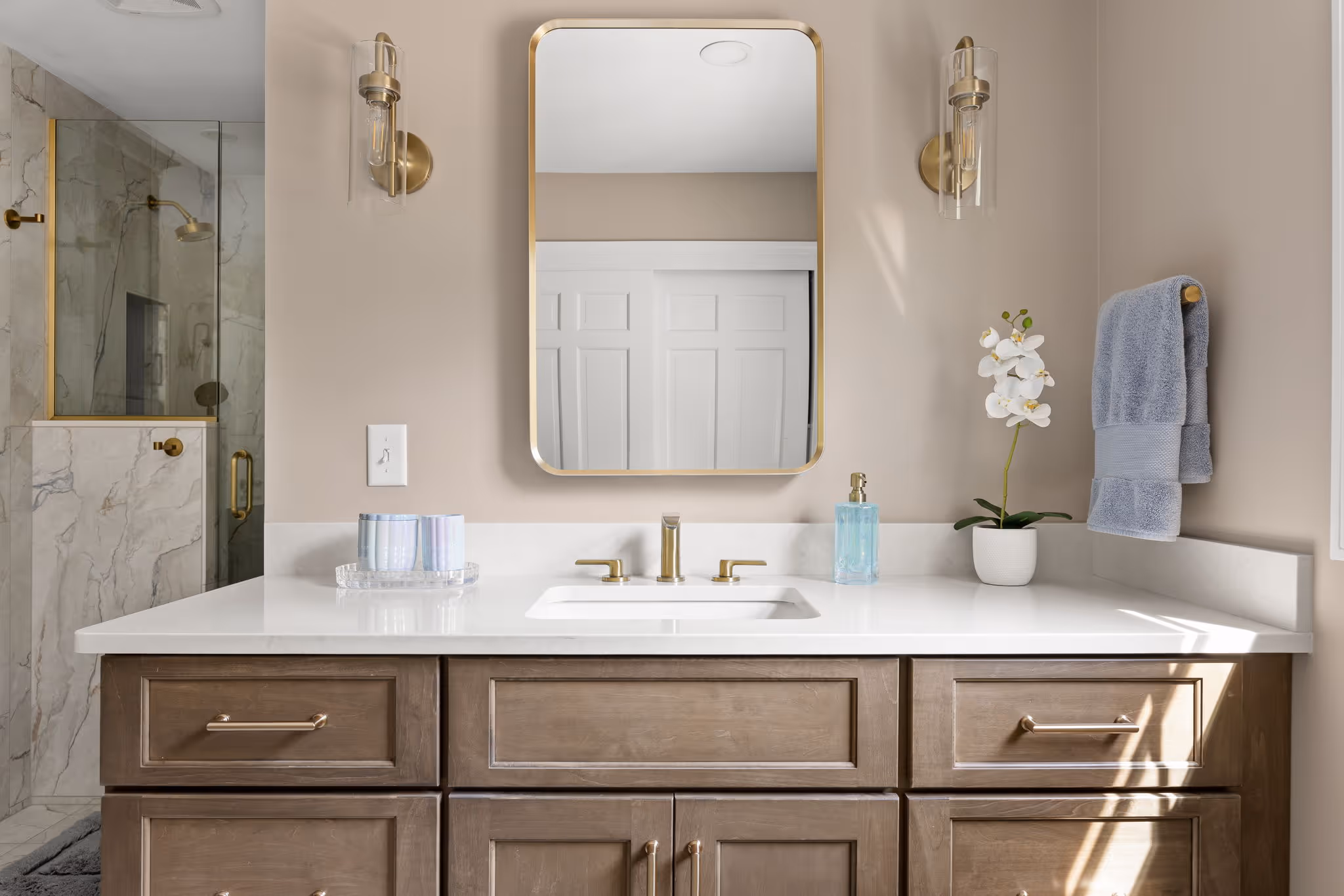 Wide view of bathroom with vanity and shower