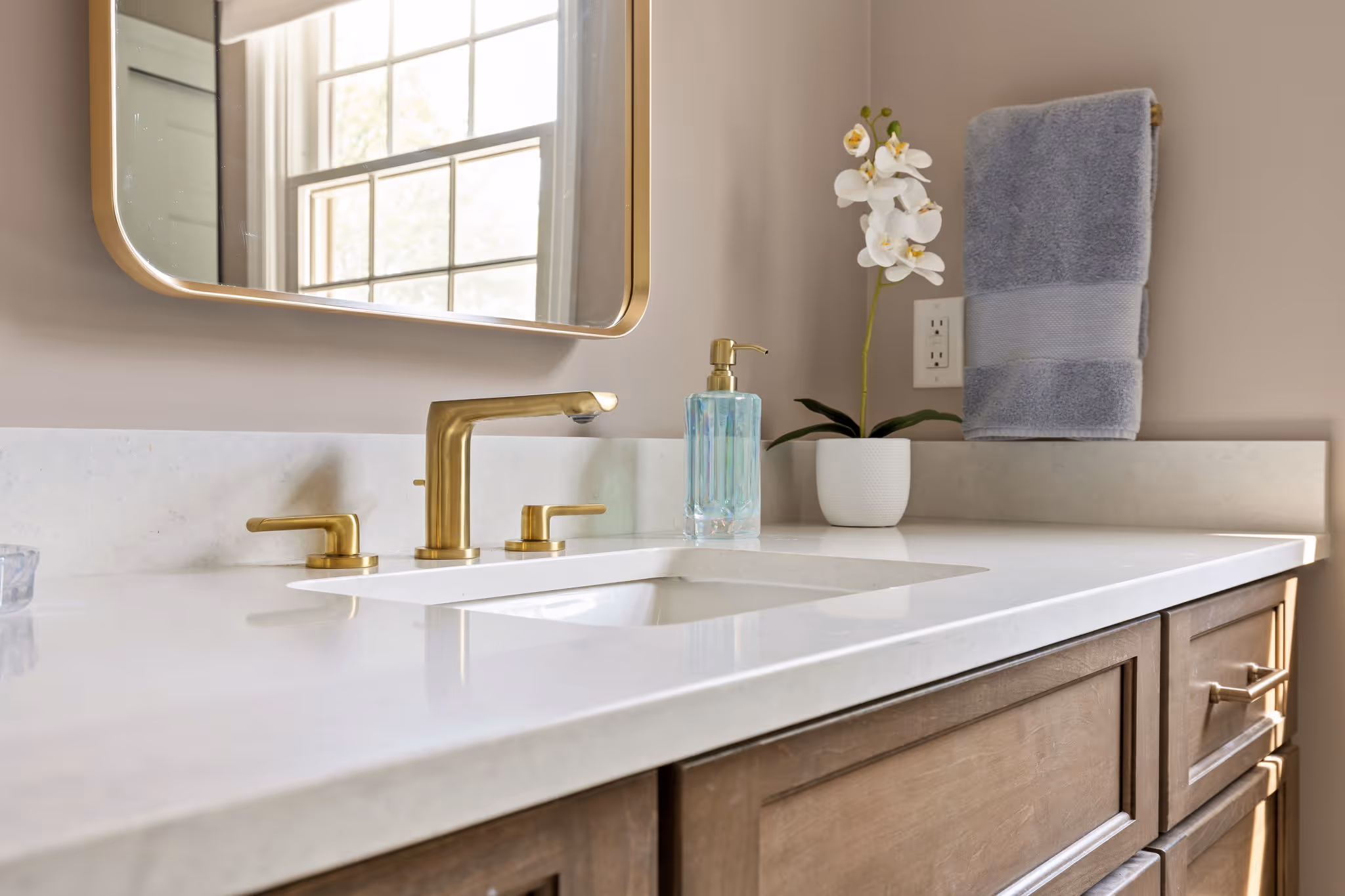Marble shower with glass door and brass fixtures