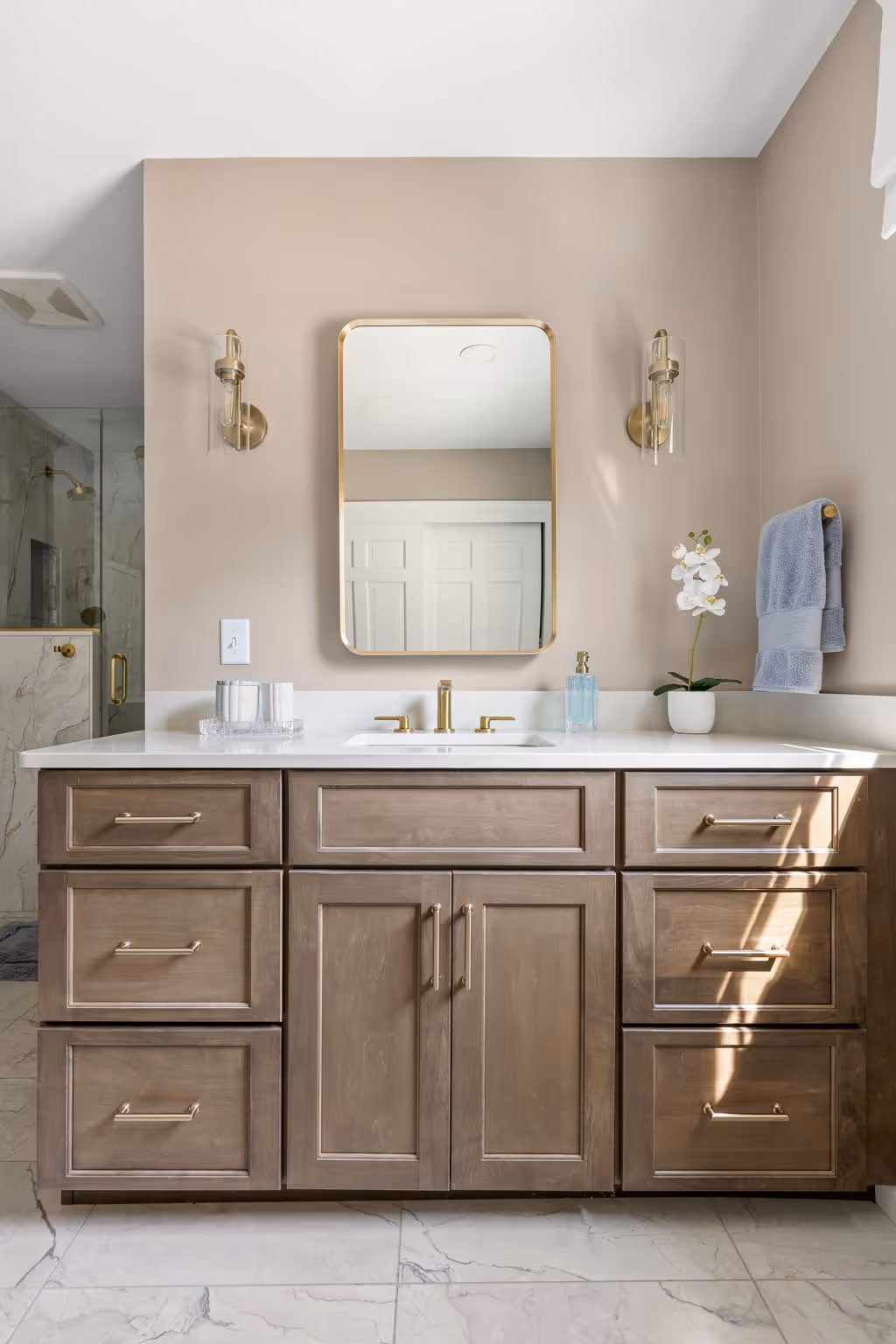 Wide view of bathroom with vanity and shower