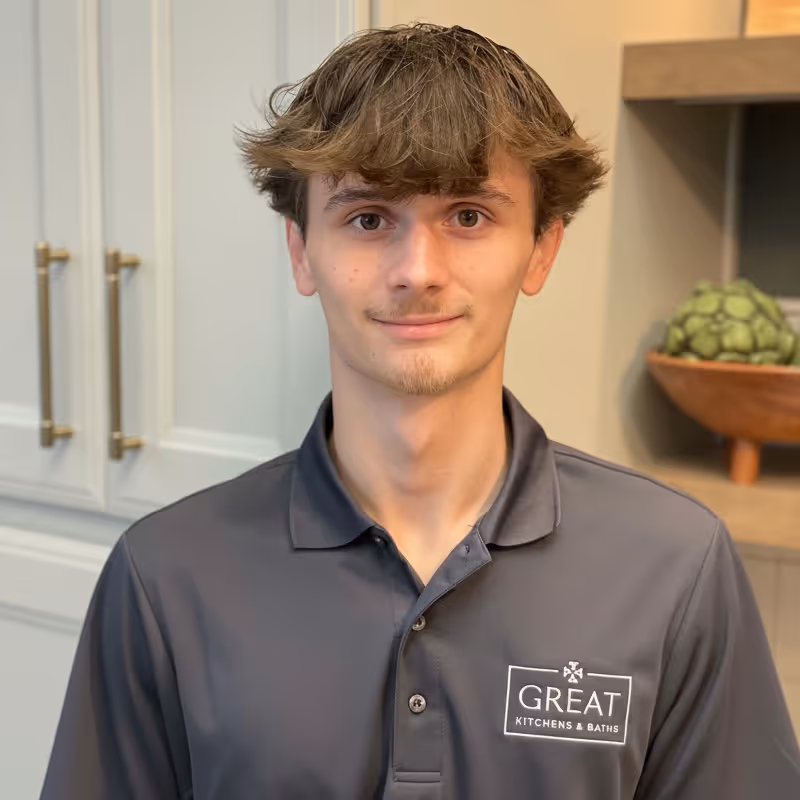 Professional headshot of man in black shirt