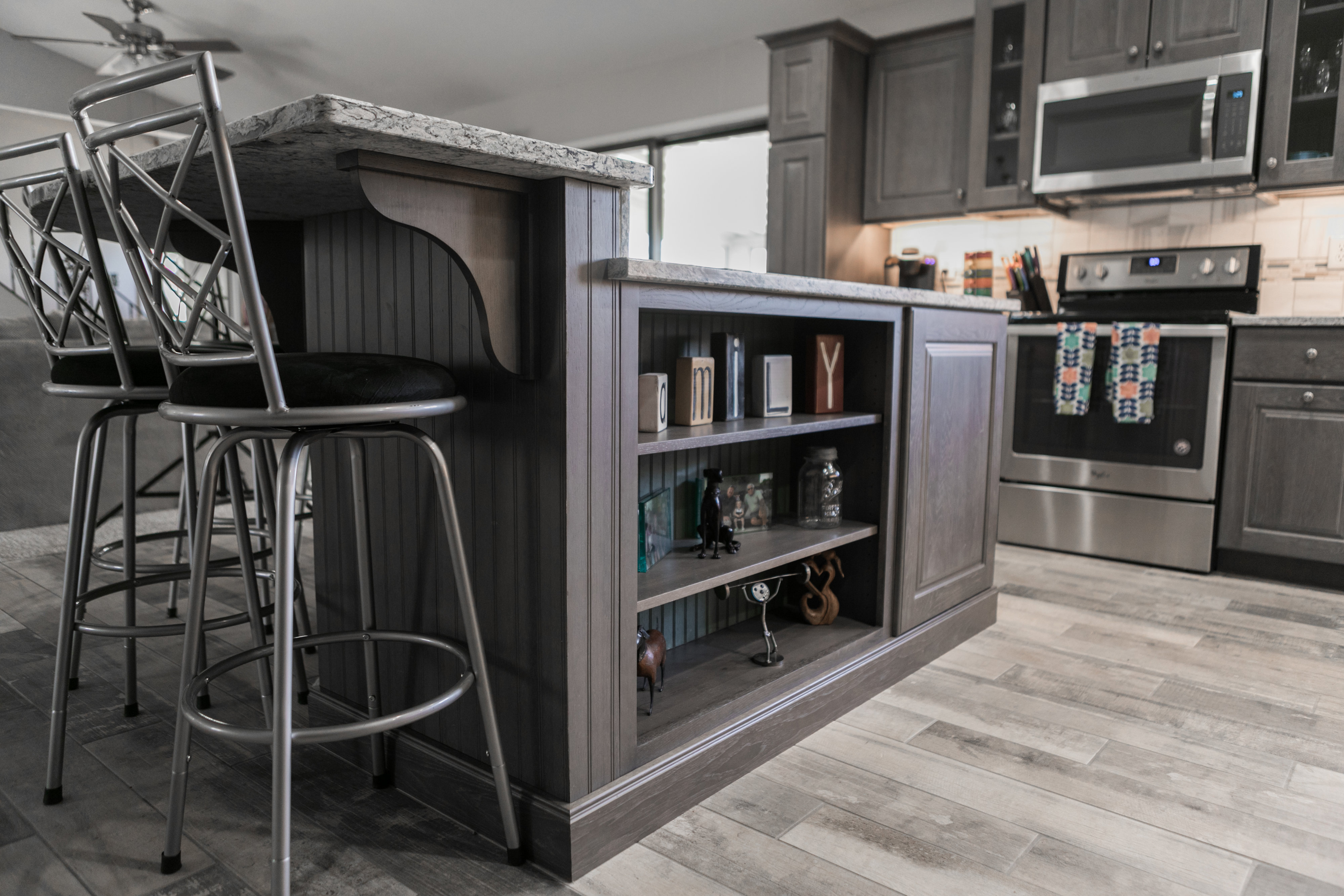 Contemporary kitchen with dark cabinets and bar seating.