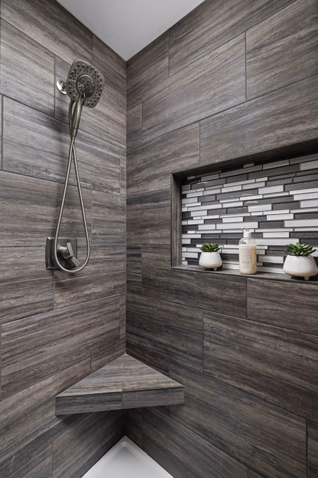 Hallway with patterned tile flooring and ceiling light
