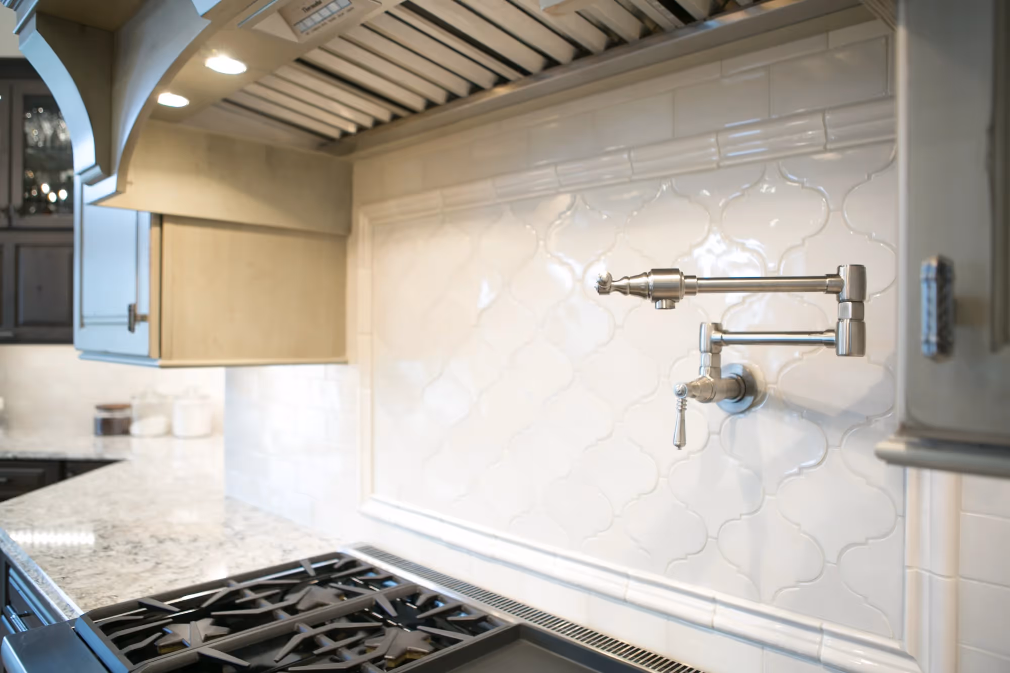 Modern kitchen backsplash with floating shelves and cooktop