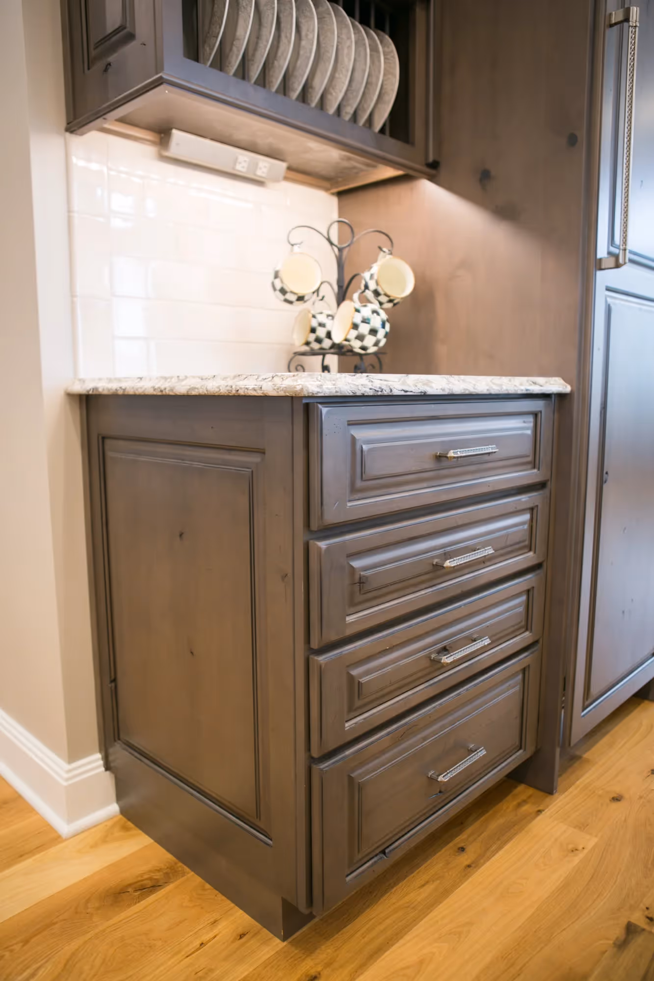 Kitchen island with wood cabinetry and stone countertop