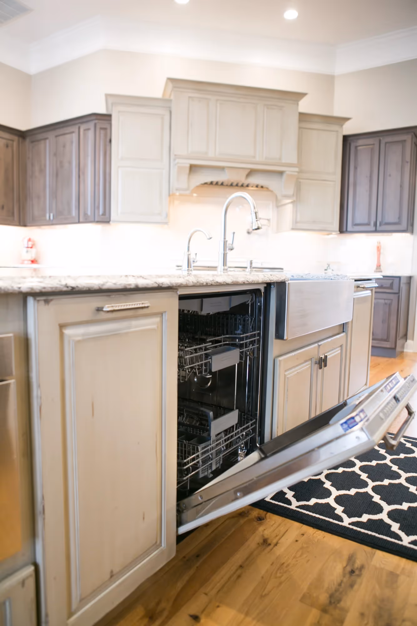 Compact kitchen with light wood cabinets and dark countertops