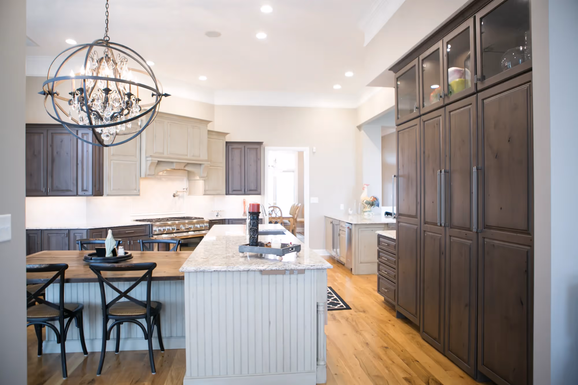 Open kitchen and dining area with dark cabinetry