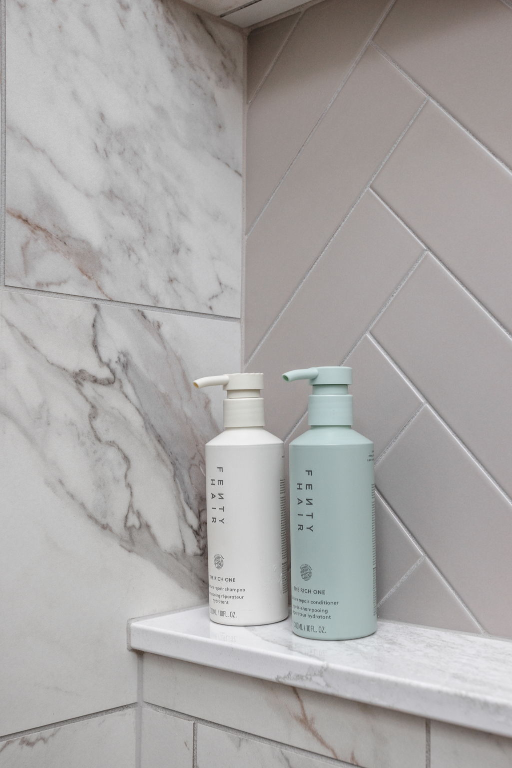 Corner shower shelf with bottles in marble bathroom