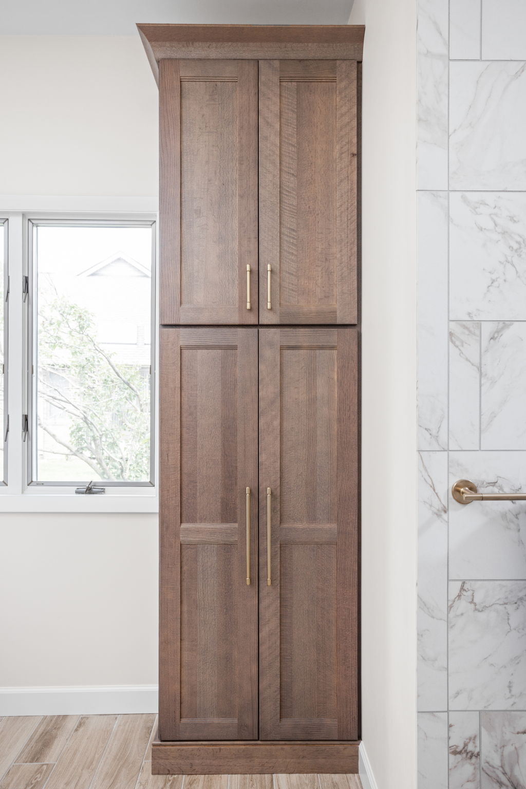 Tall wooden cabinet with marble surround