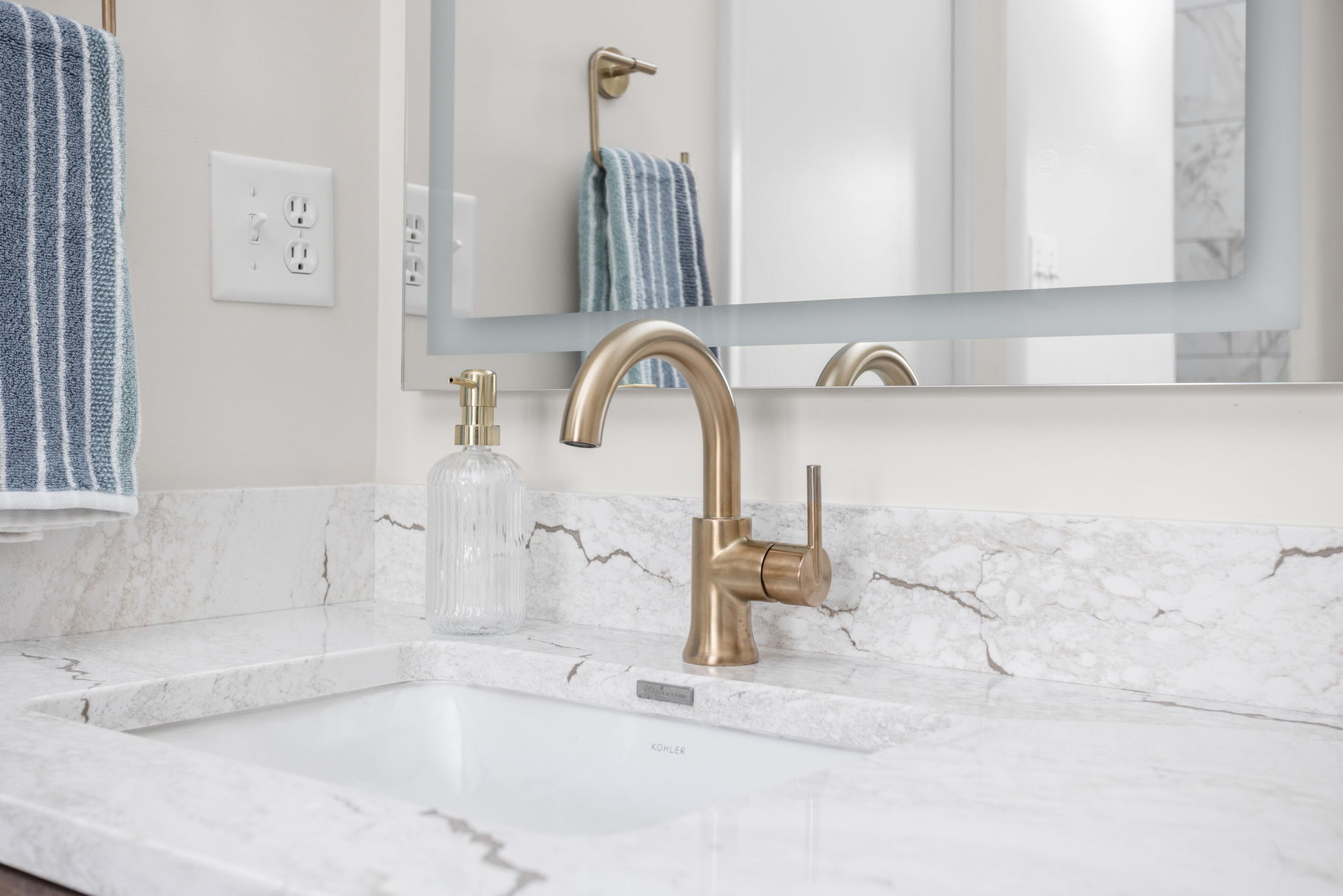 Marble bathroom countertop with brass faucet