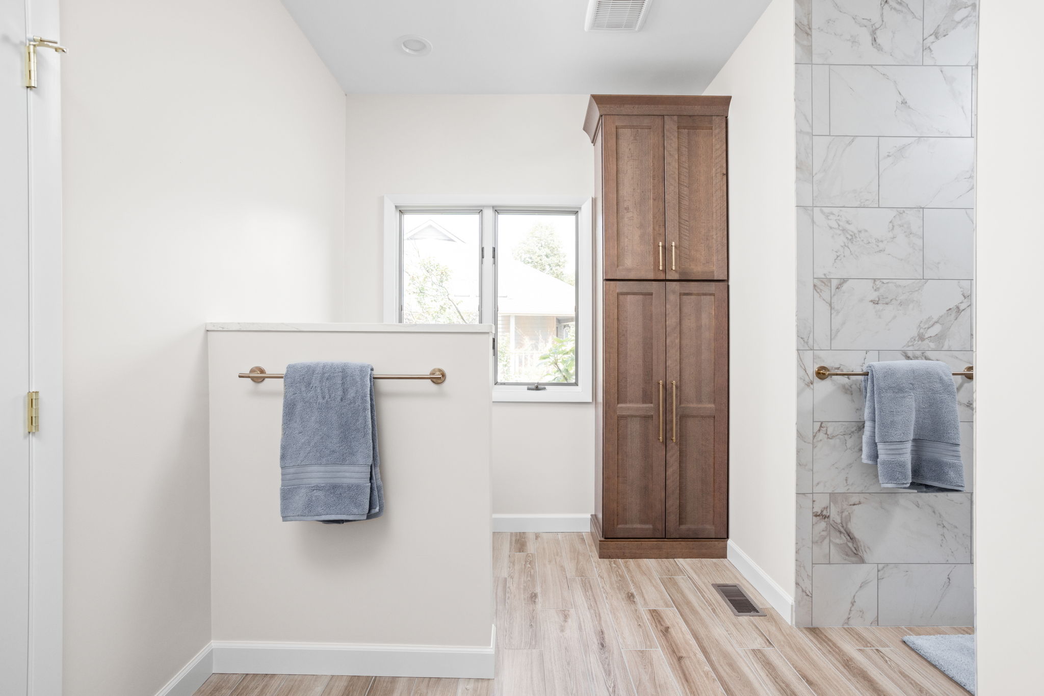 Bathroom vanity area with doorway to hall