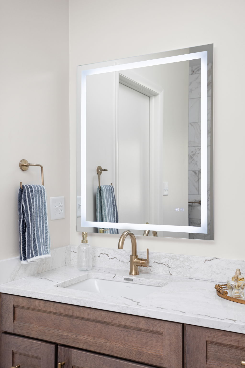 White kitchen sink with chrome faucet and marble-look counter