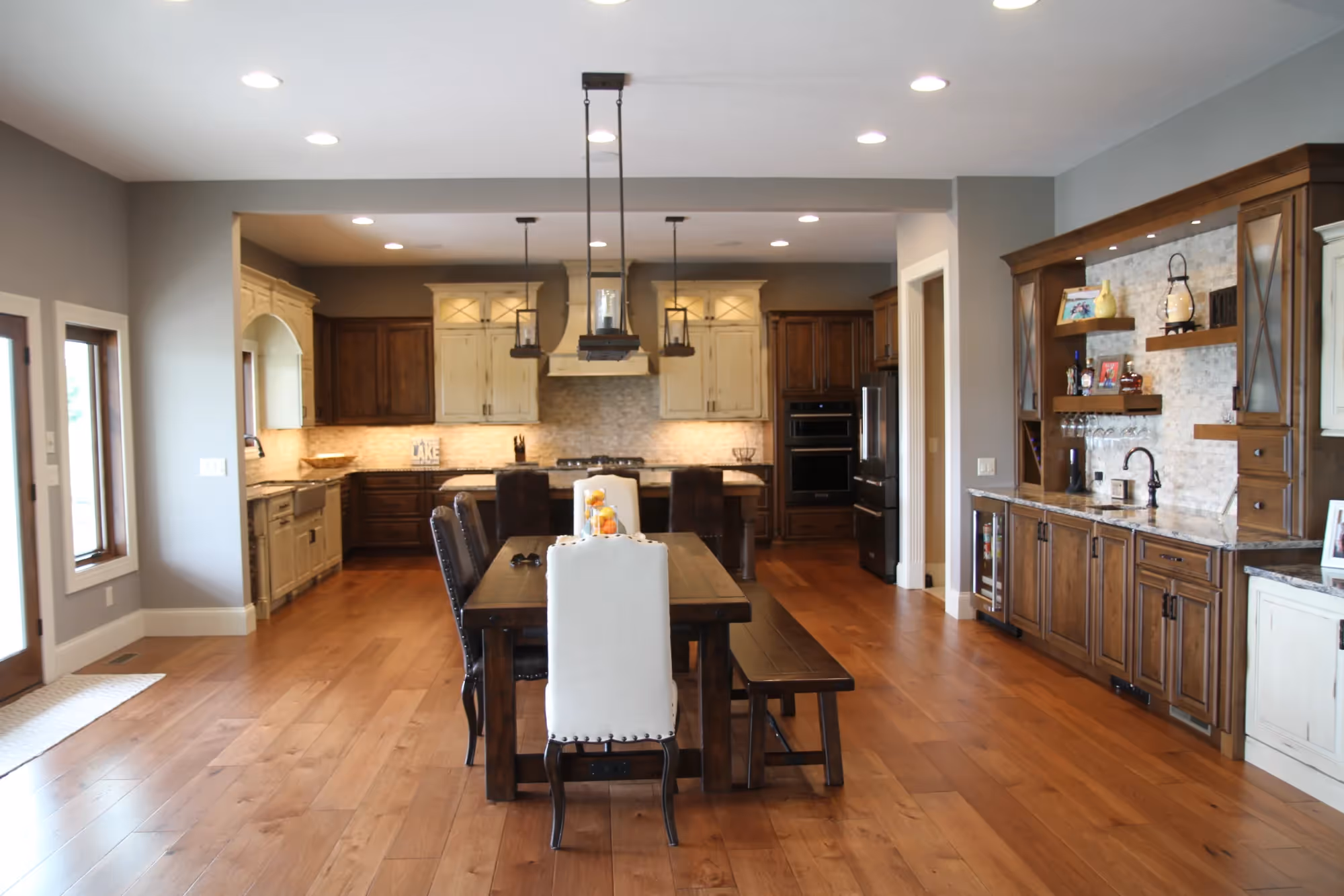 Open-concept kitchen and dining area with hardwood floors.