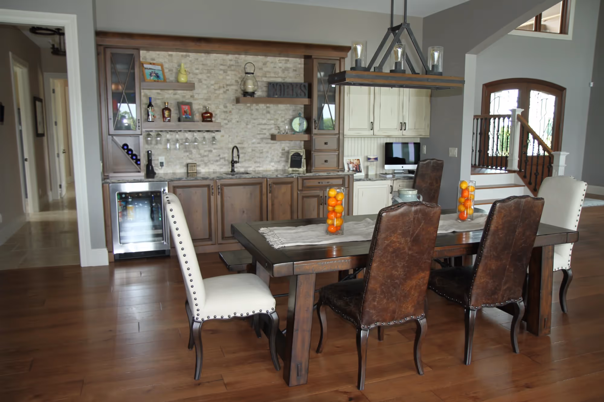 Dining room with a wooden table and six upholstered chairs.