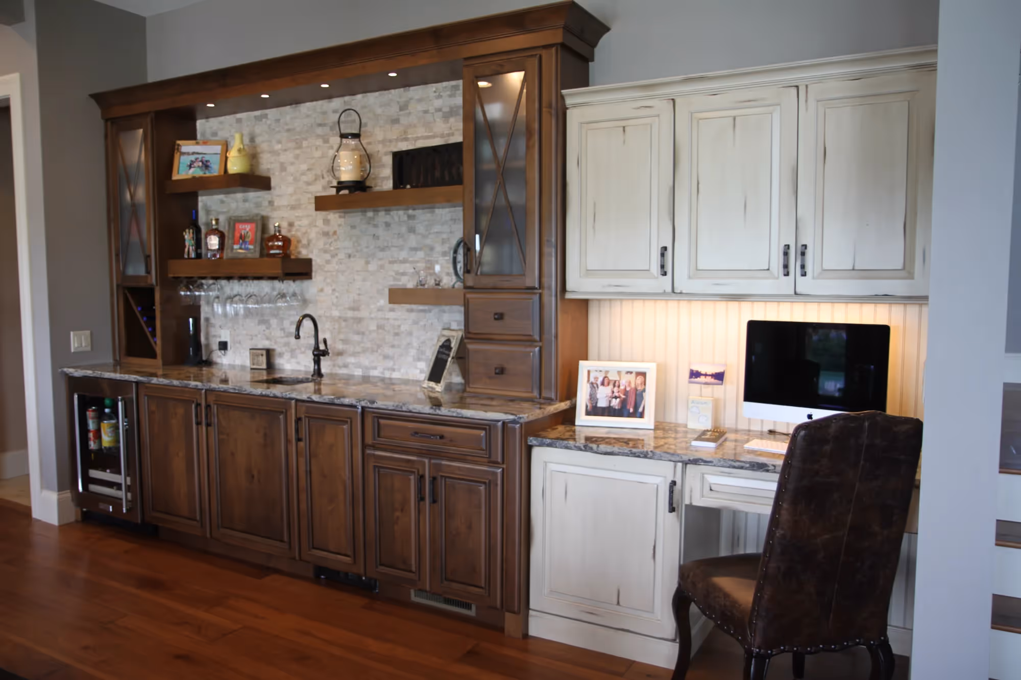 Home office area with built-in wooden cabinets and desk.