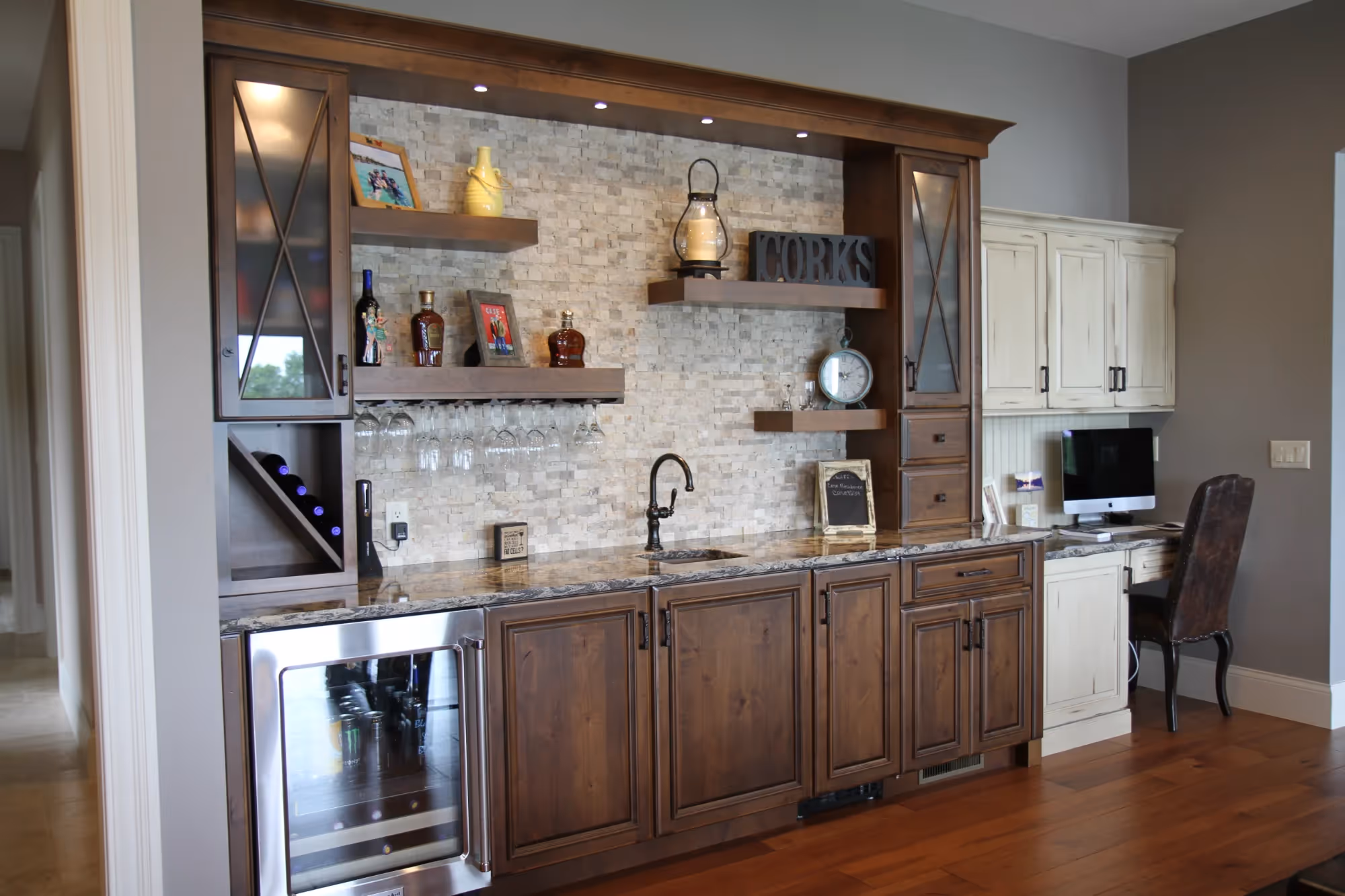 Living area with a wooden bar cabinet and display shelves.
