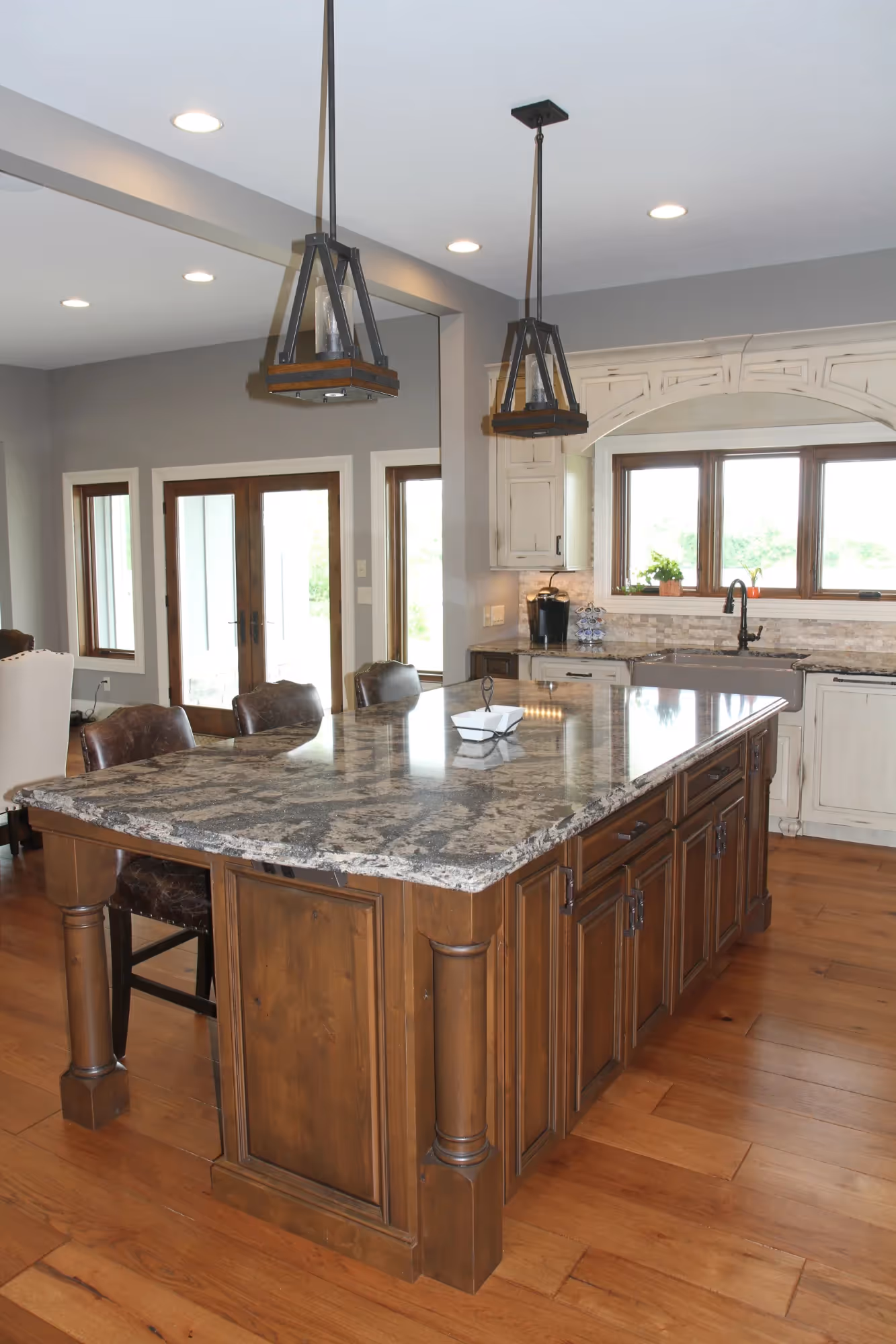Kitchen with large wooden island and bar stools.