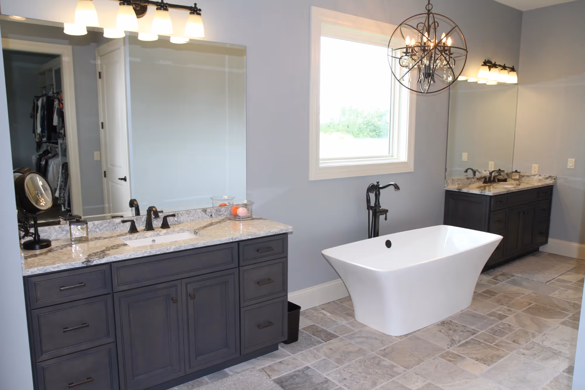Modern bathroom with freestanding tub and dark vanity