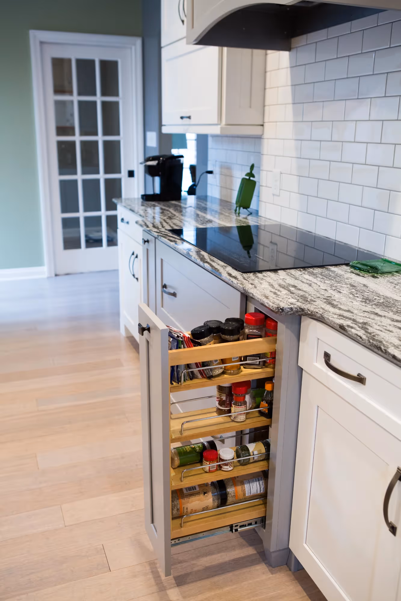 Pull-out pantry storage beside refrigerator