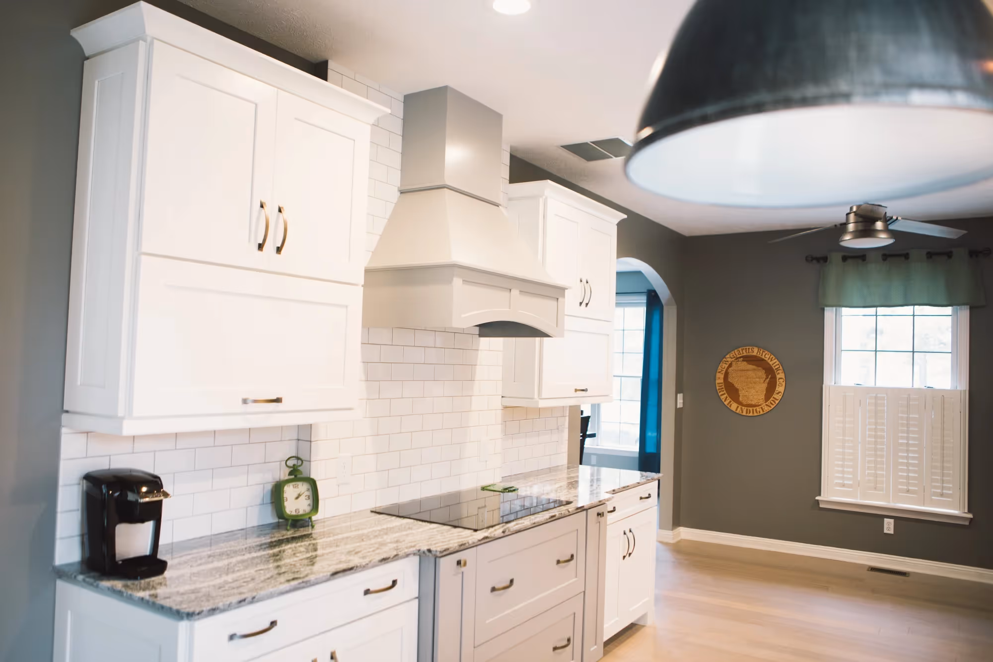 Kitchen corner with pendant light and white cabinets