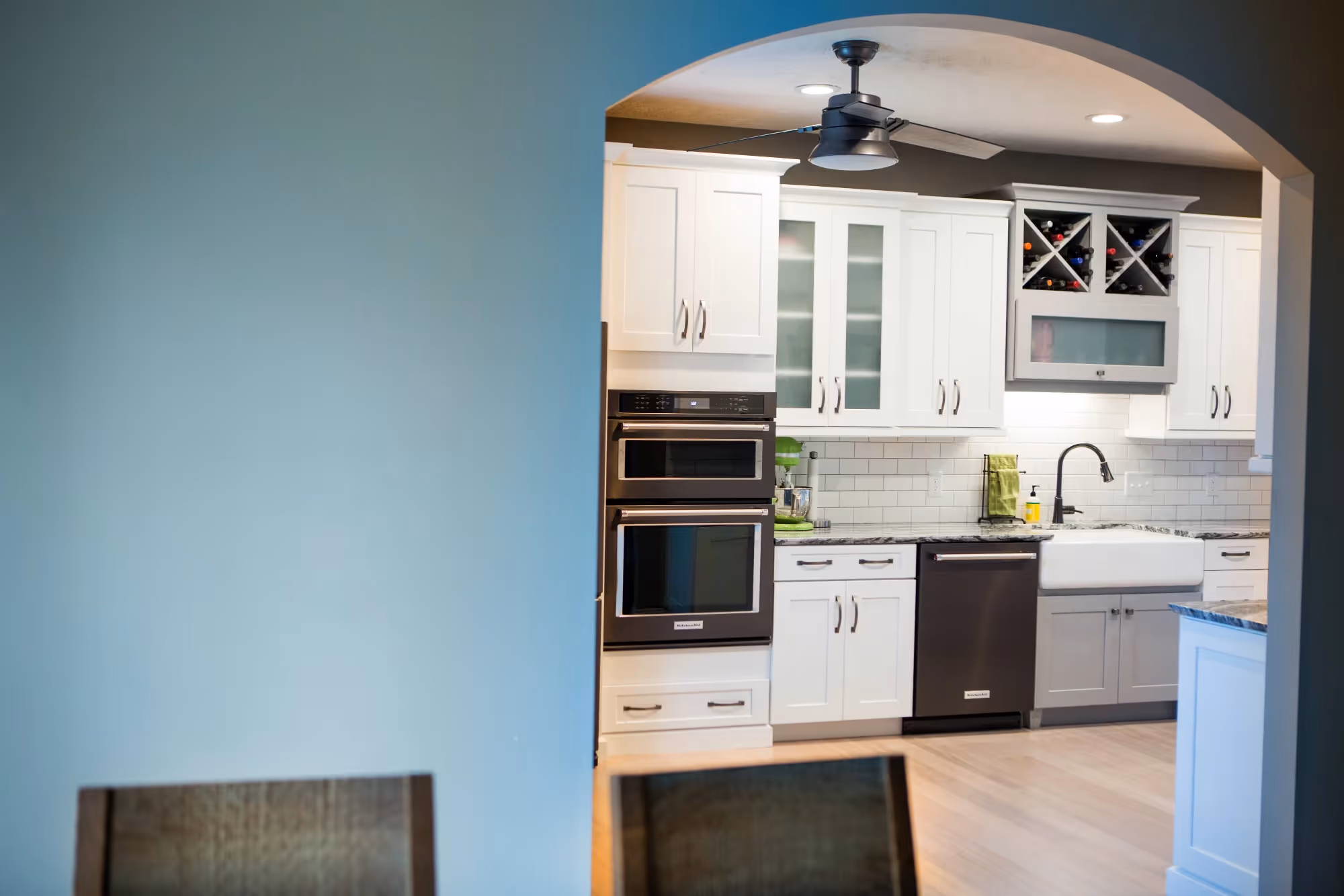 White kitchen with blue wall and built-in oven