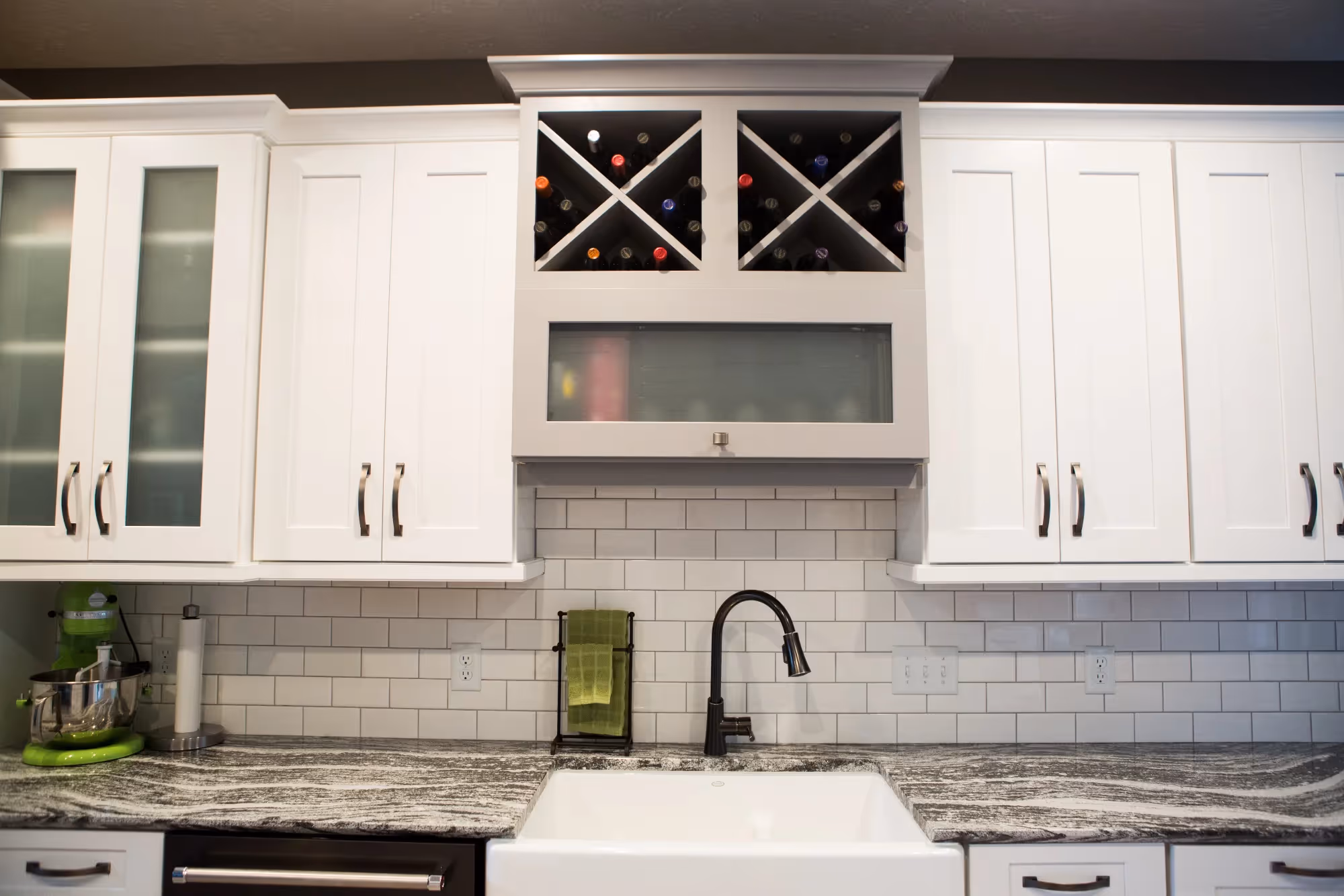 White kitchen sink with cabinets and window