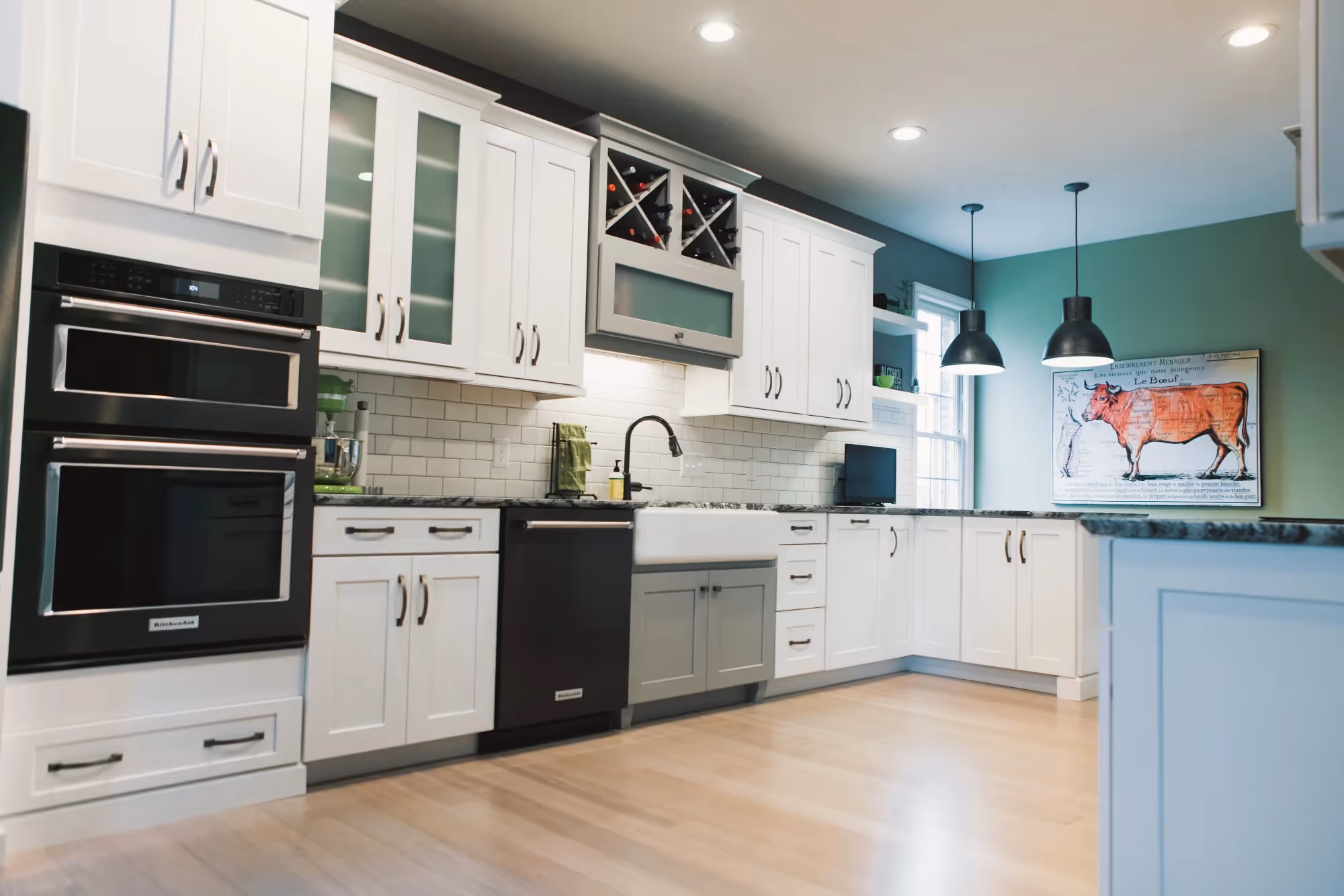 Built-in stainless oven and cooktop in white kitchen
