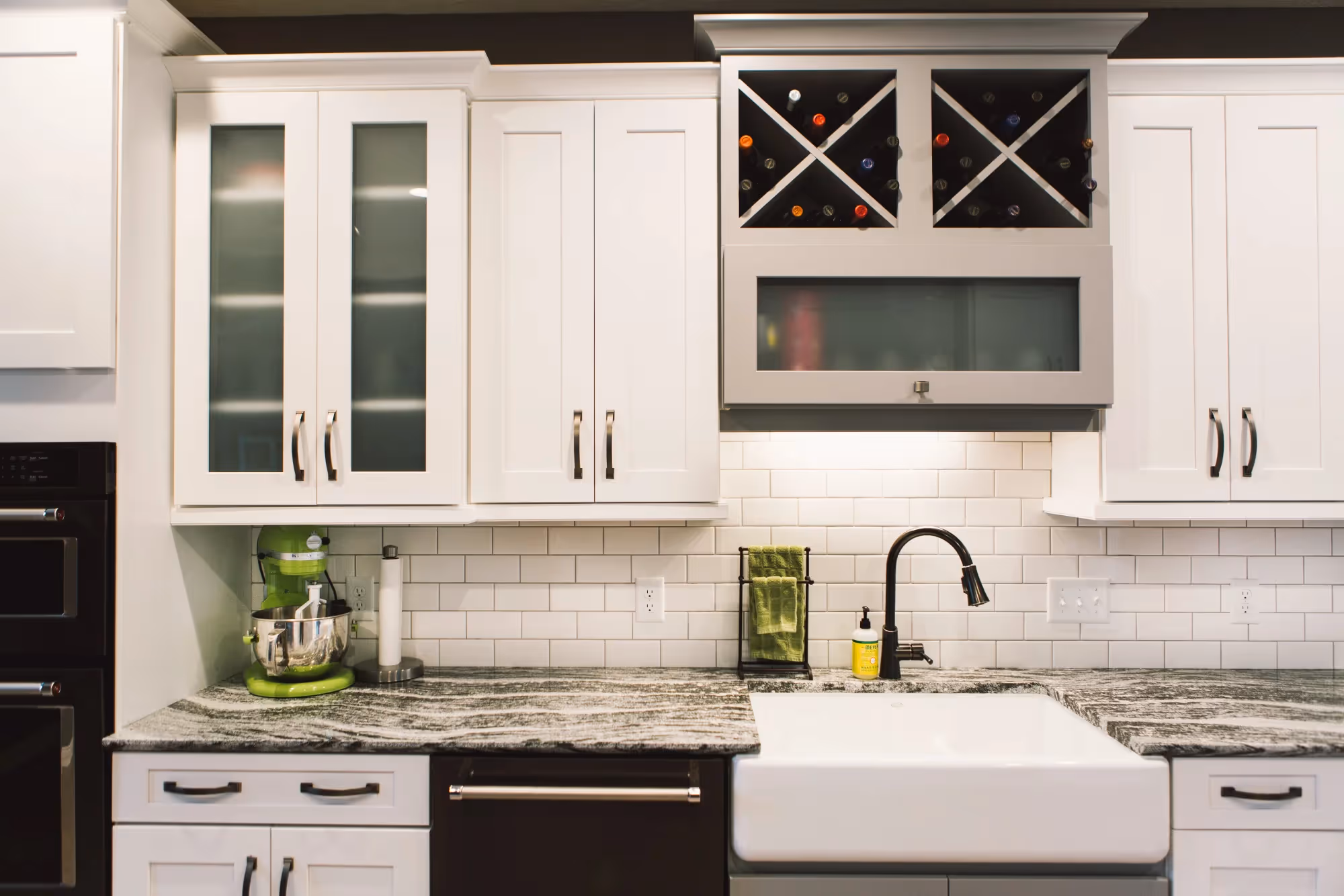 White cabinets with built-in wine rack and counter
