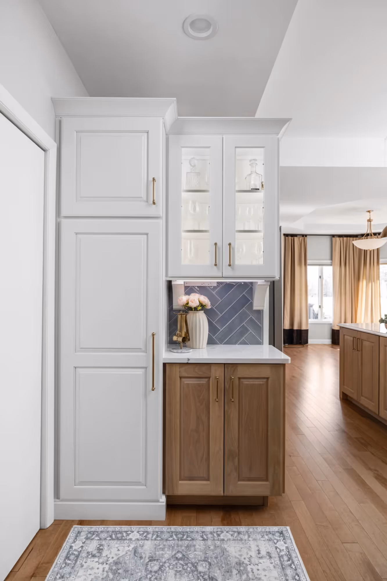 White Cabinet with wood cabinets and wooden flooring