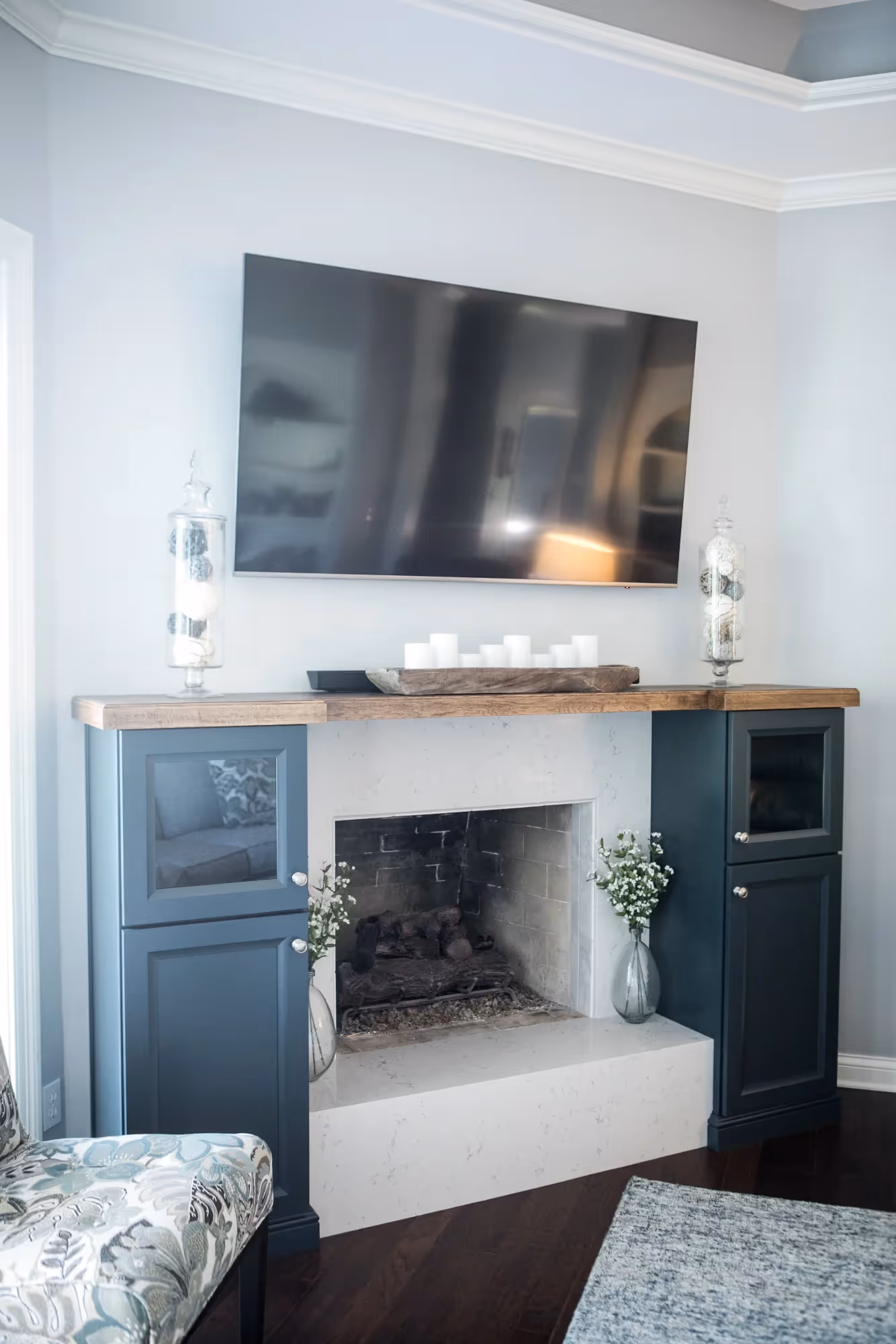 Cozy living room corner with gray couch and wall-mounted TV.