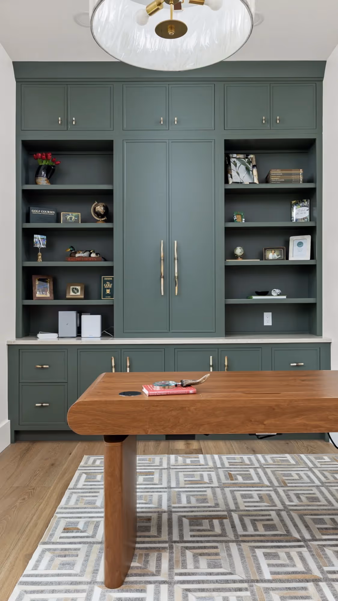 Home office with blue cabinets and wooden countertop.