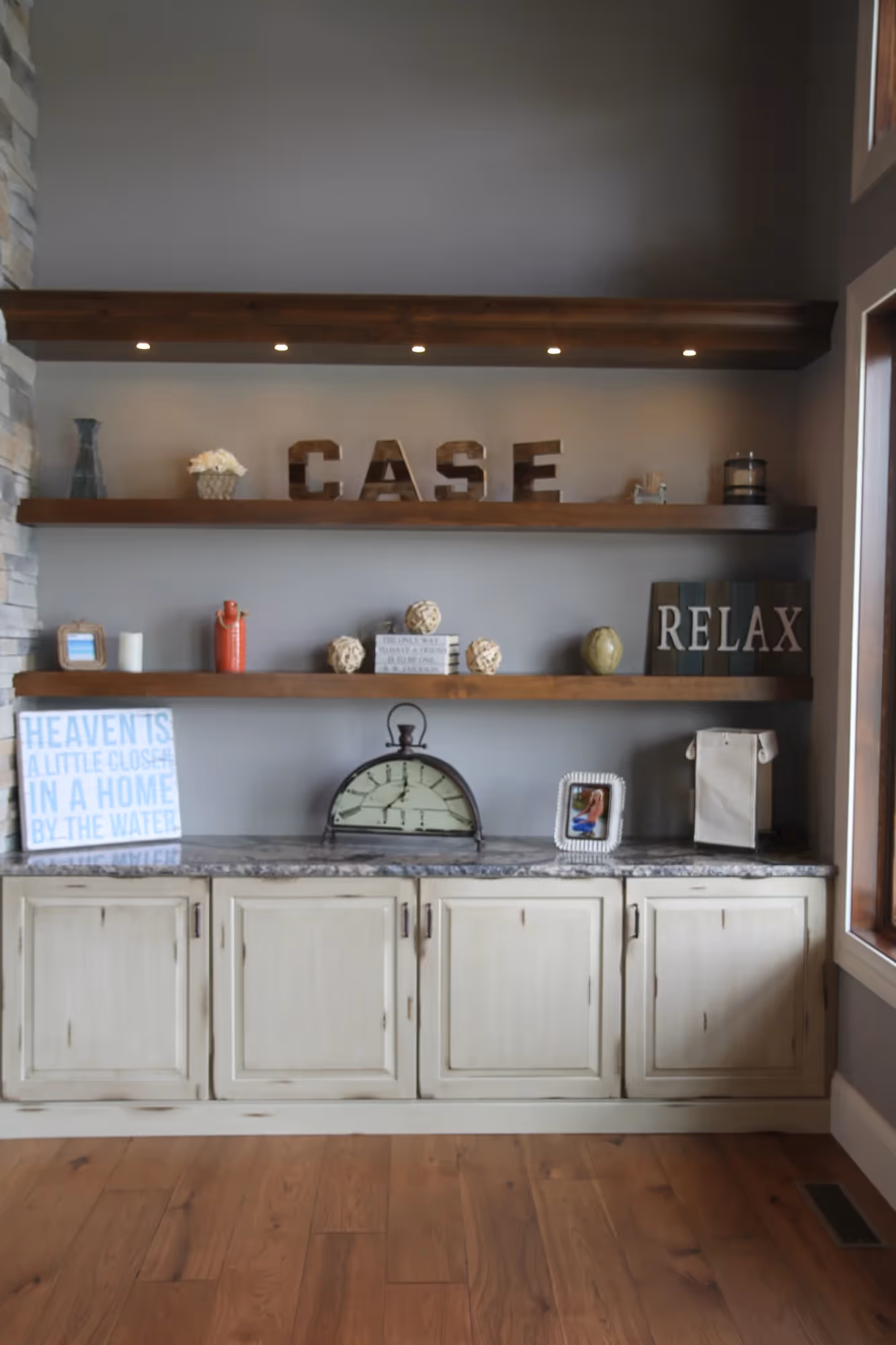 Wooden floating shelves with books and decorative items.